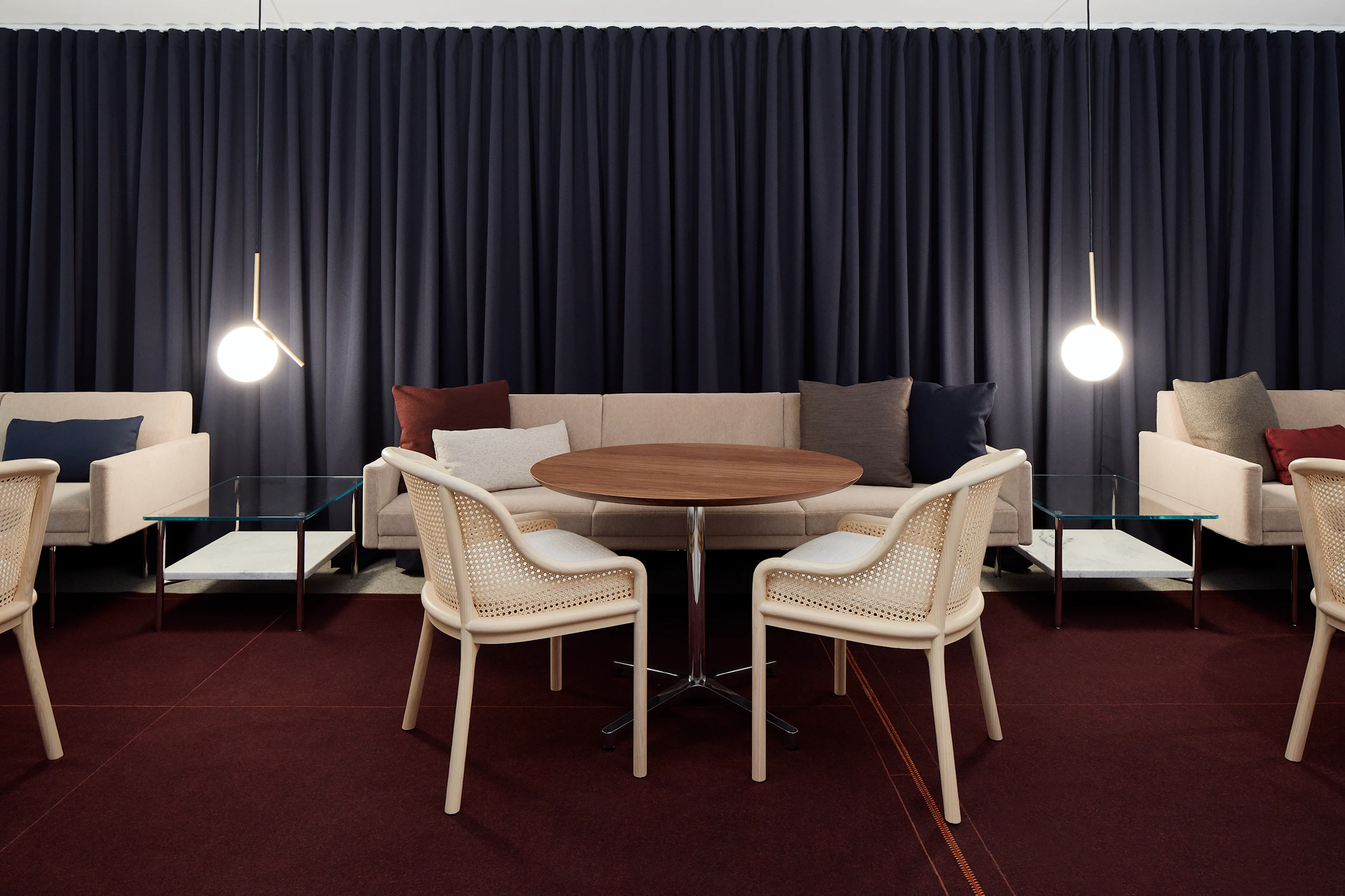 A lounge setting in the Geiger showroom featuring Tuxedo Component Sofas, Landmark Chairs, Saiba Tables, and Layer Tables.