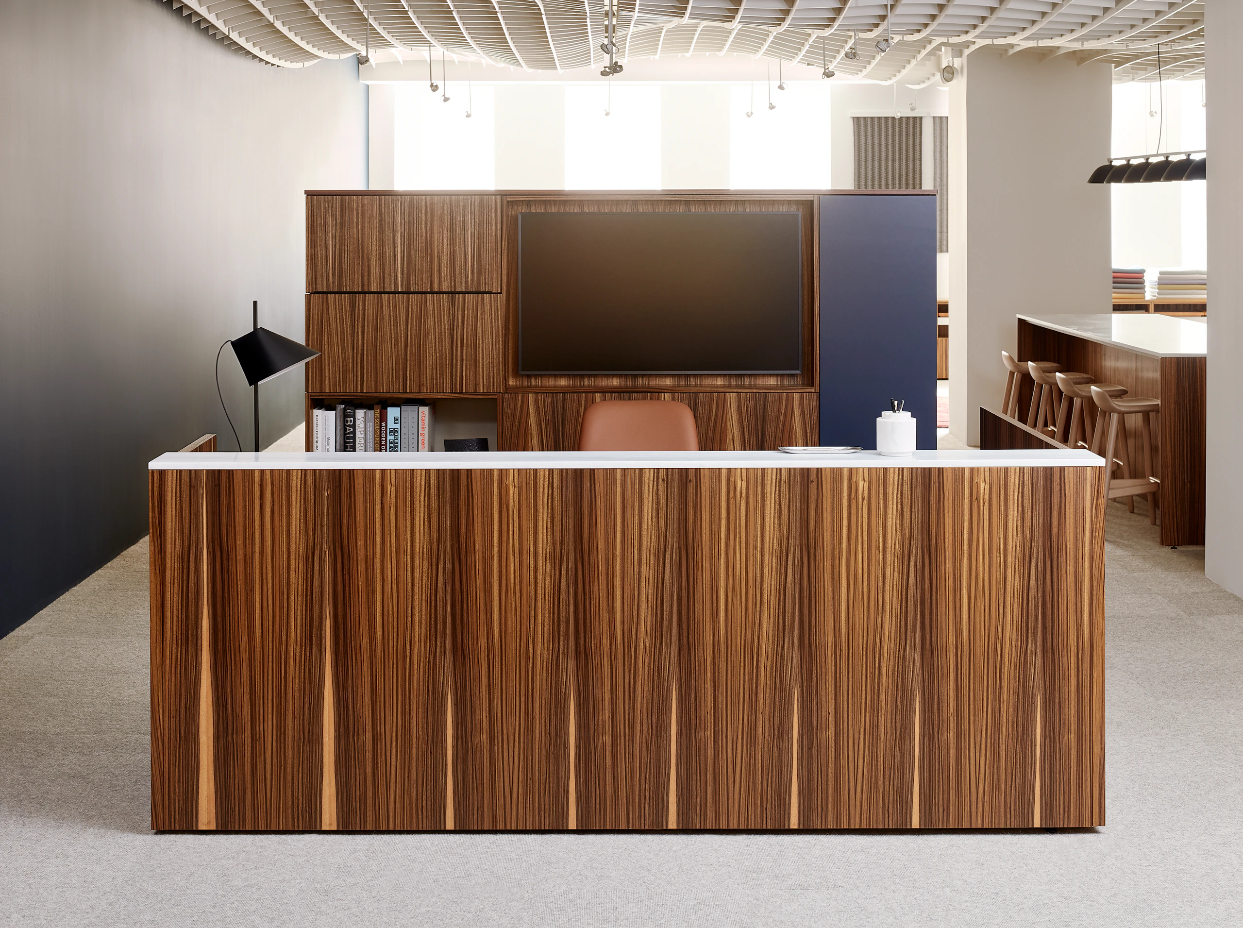 A reception station featuring Geiger One Casegoods and a Saiba Chair.