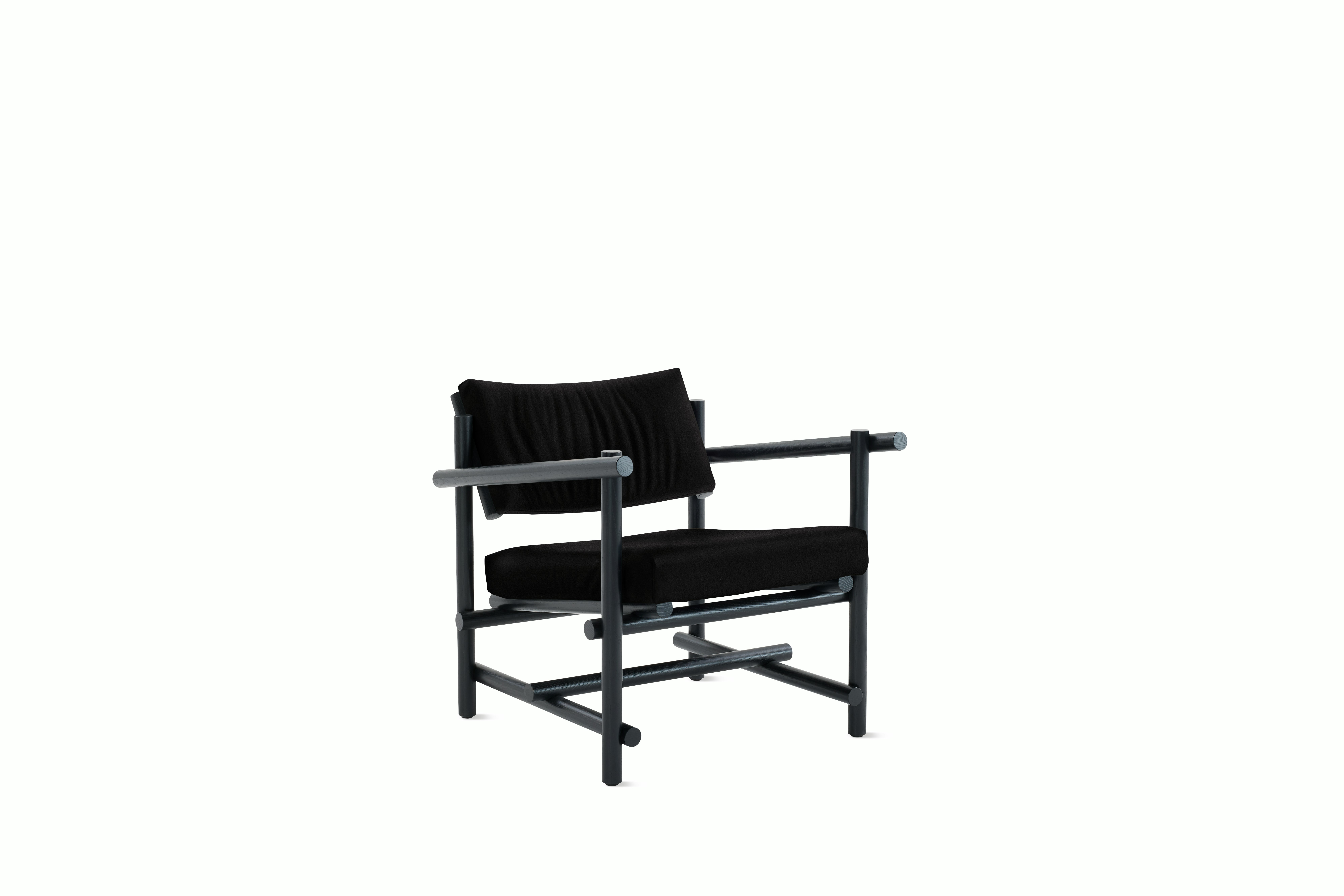A Muecke Lounge Chair in Ebony Ebonized Ash viewed from an angle.