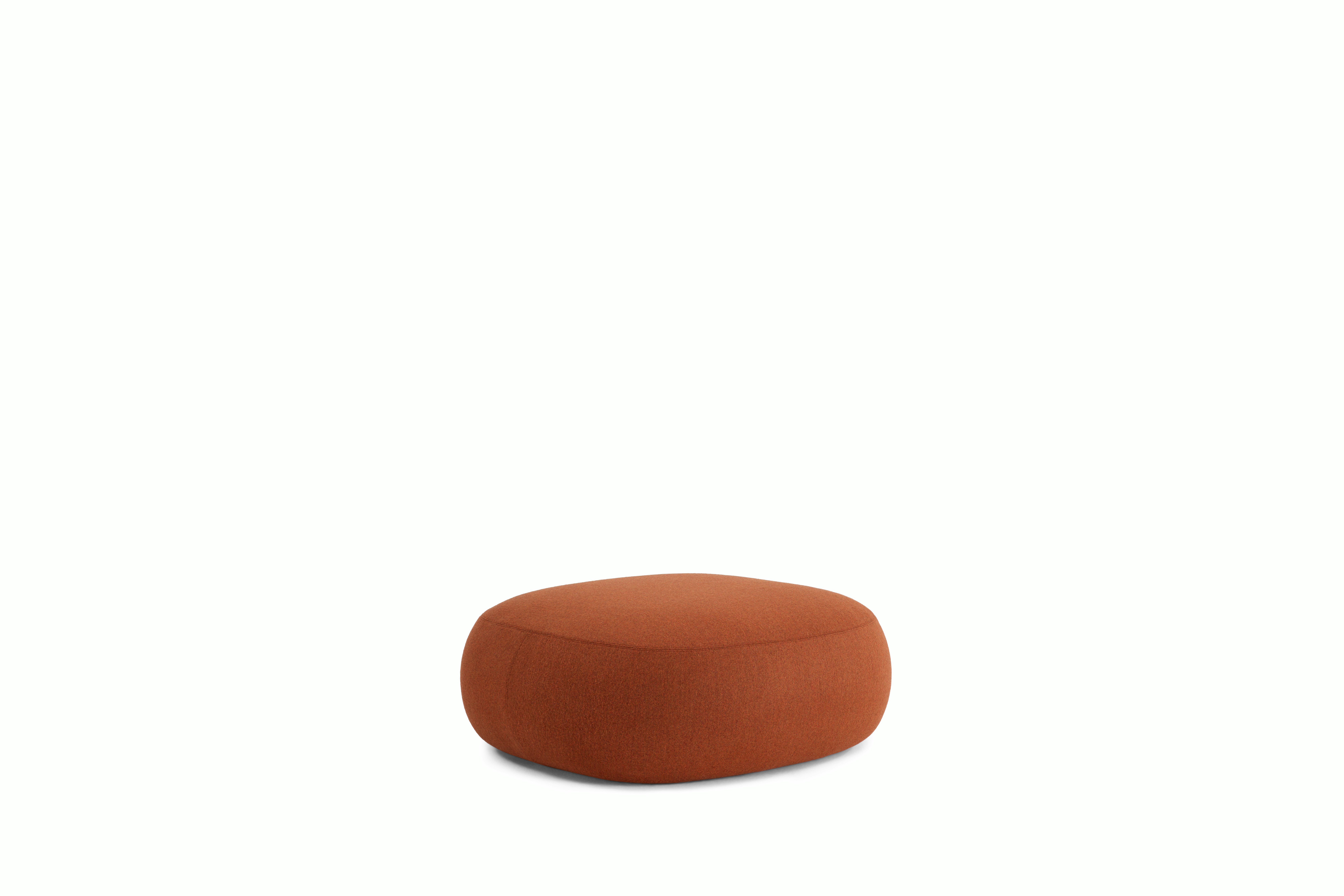 A Biboni Ottoman in Stellium, Iron Red viewed from an angle.