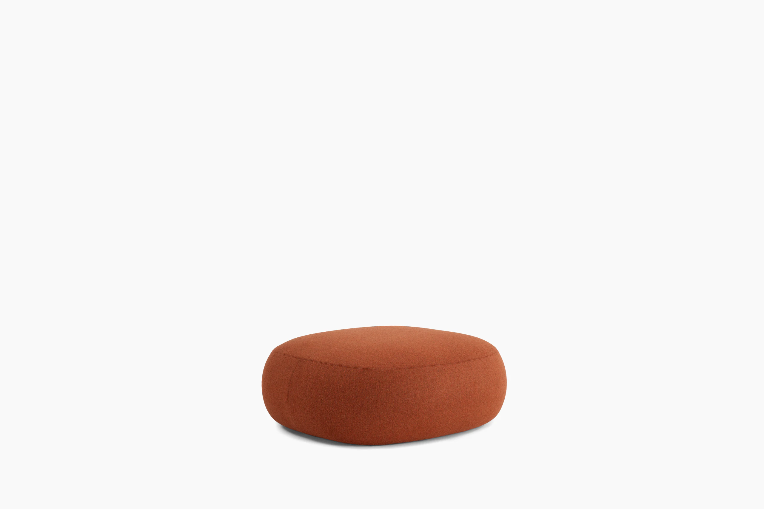 A Biboni Ottoman in Stellium, Iron Red viewed from an angle.