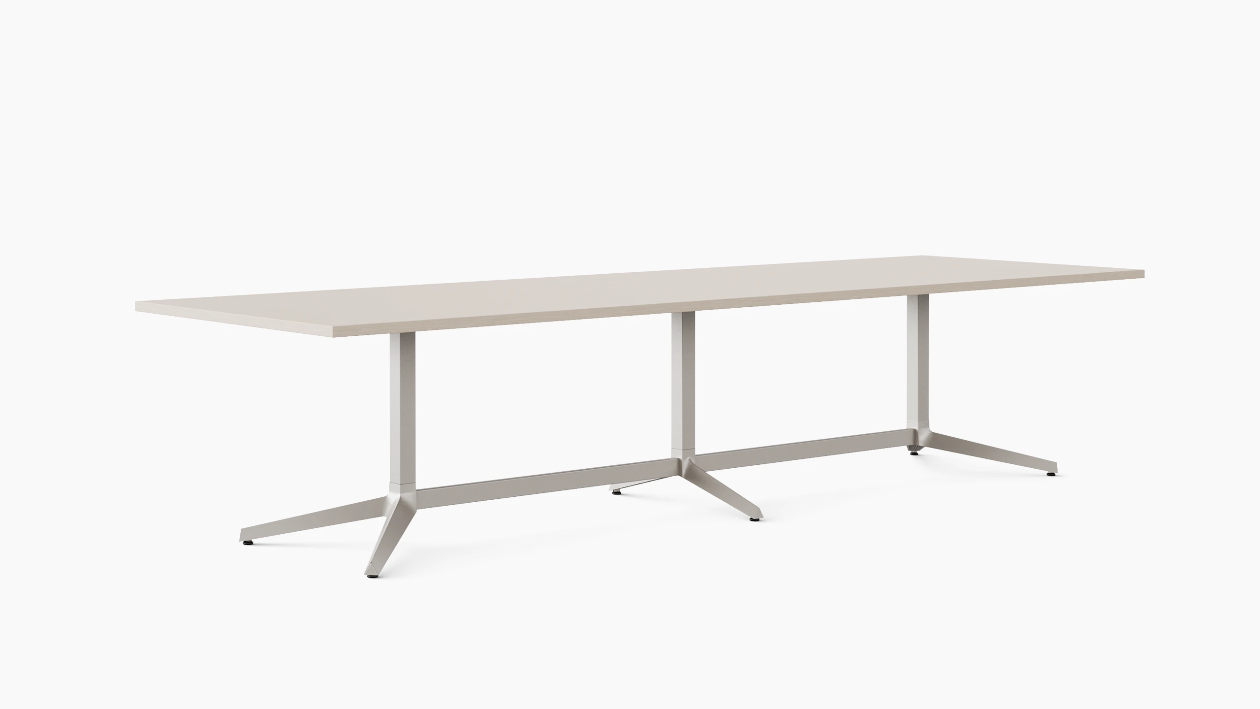 A long rectangular meeting table is shown at an angle in a light color veneer.