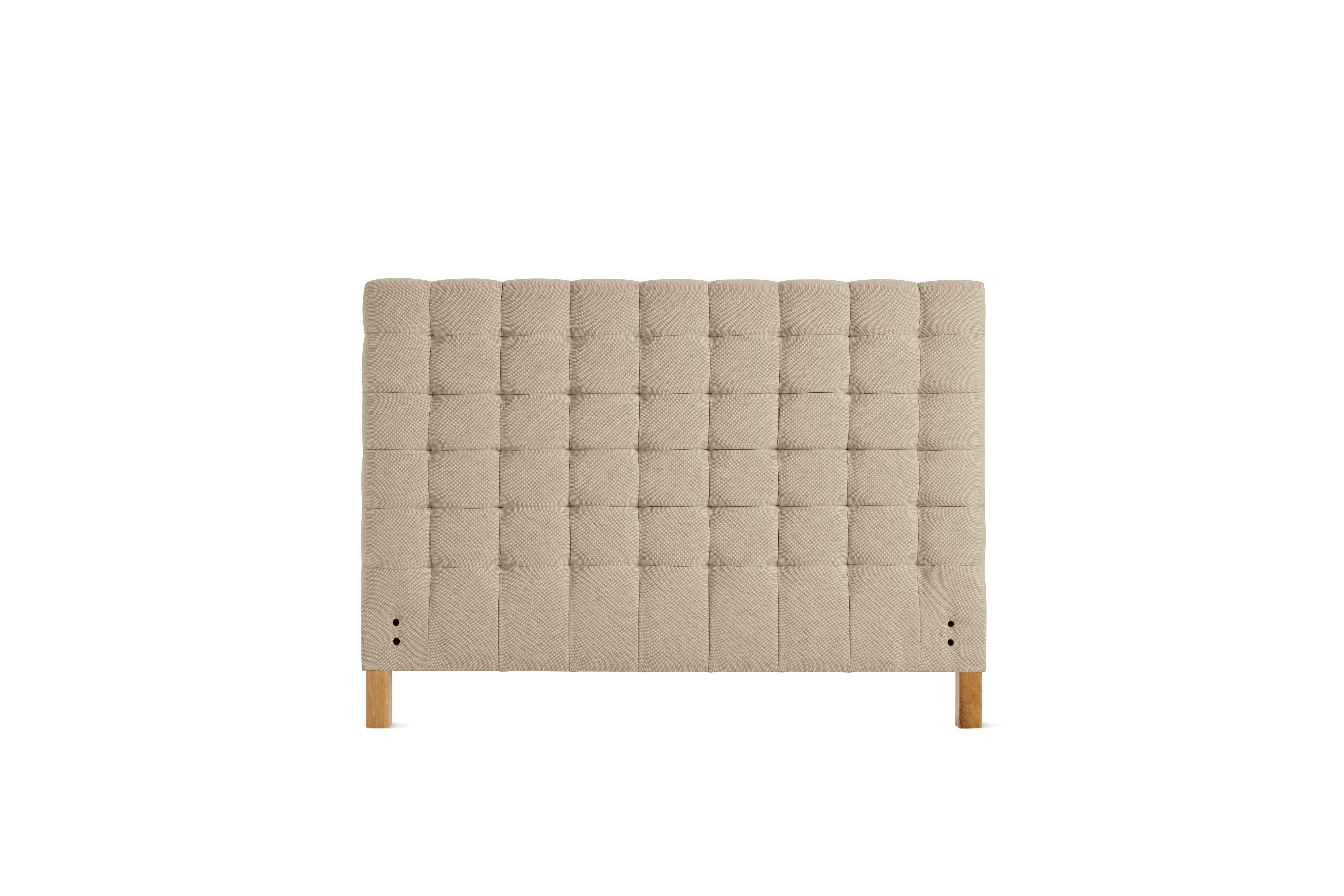 A Madeleine Headboard in Mode, Basket, Oak viewed from the front.