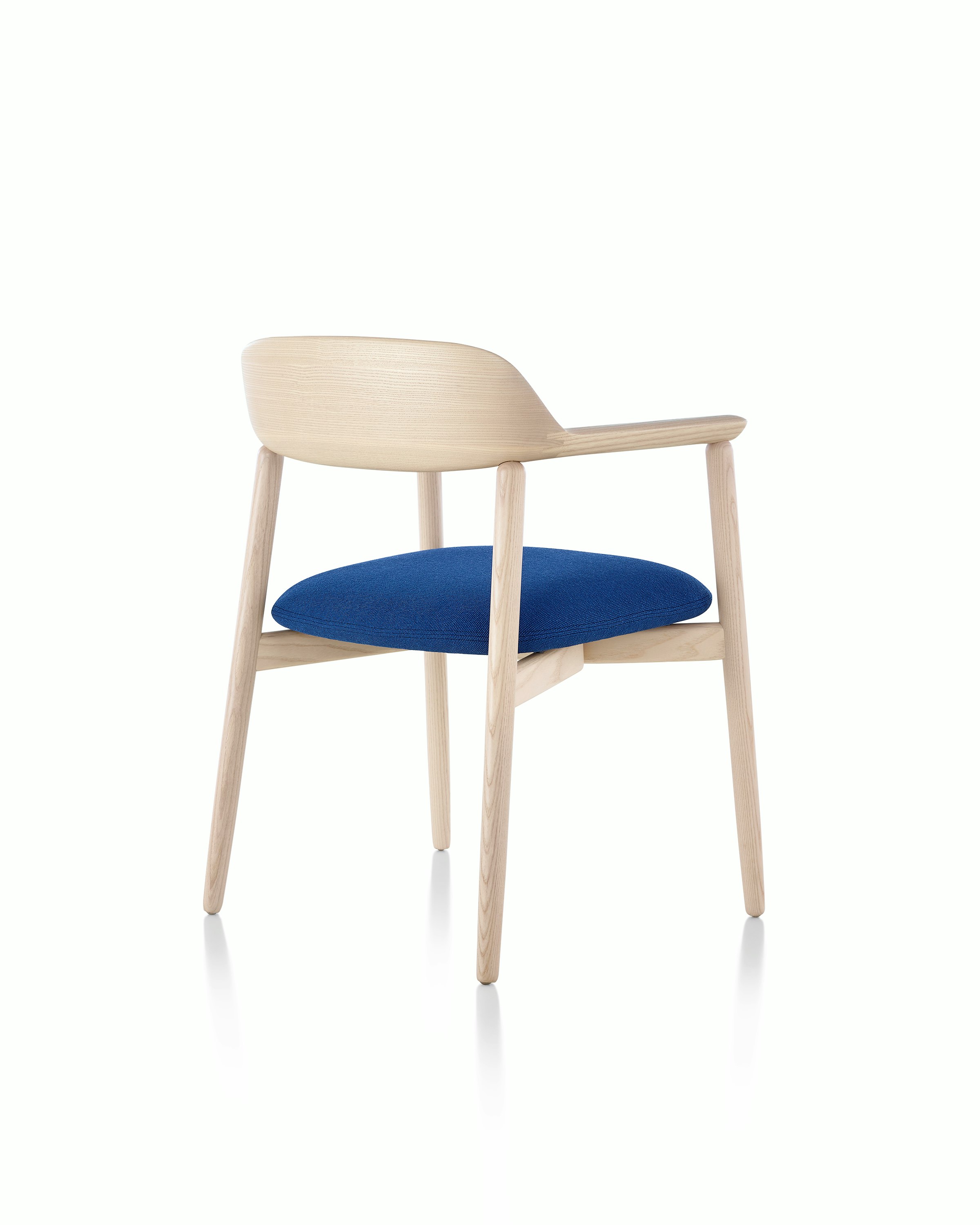 A Crosshatch Side Chair, viewed from behind at an angle to show how the upholstered seat seems to float.