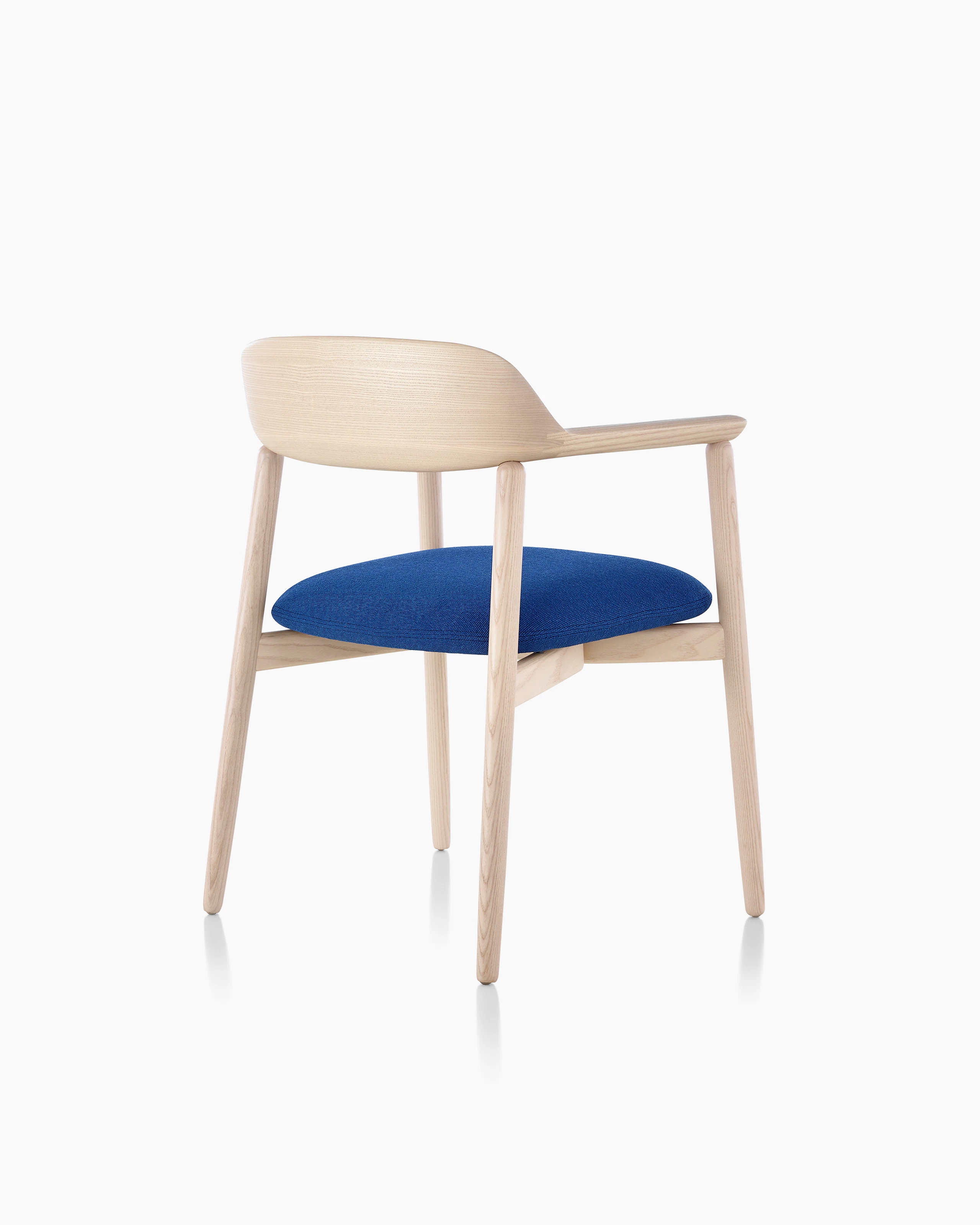 A Crosshatch Side Chair, viewed from behind at an angle to show how the upholstered seat seems to float.