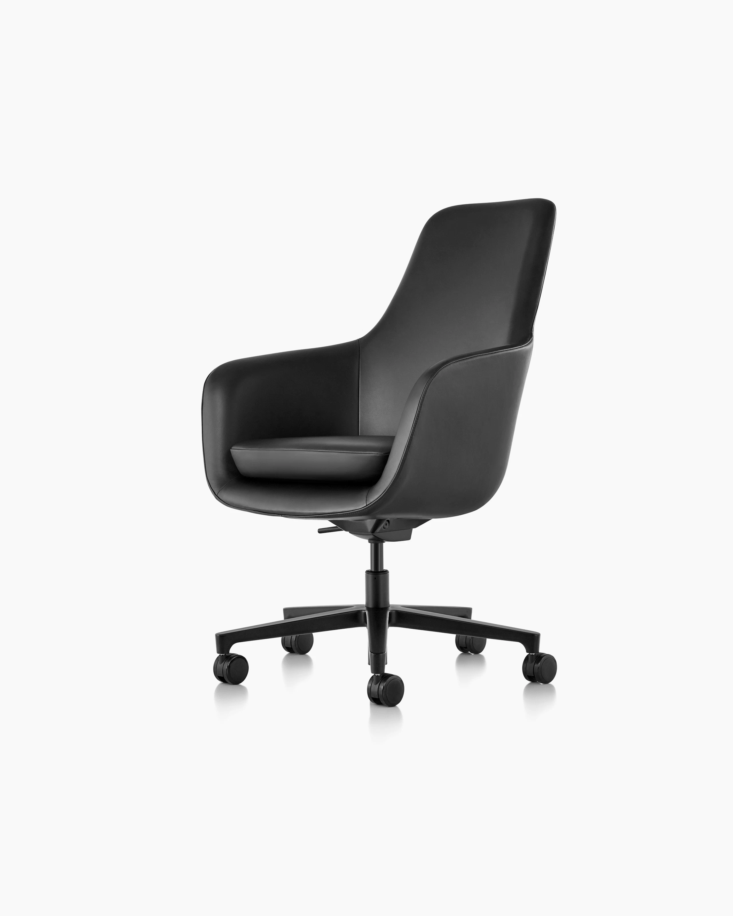 Partial angled view of the seat, back, and arms on a Saiba Chair with black leather upholstery.