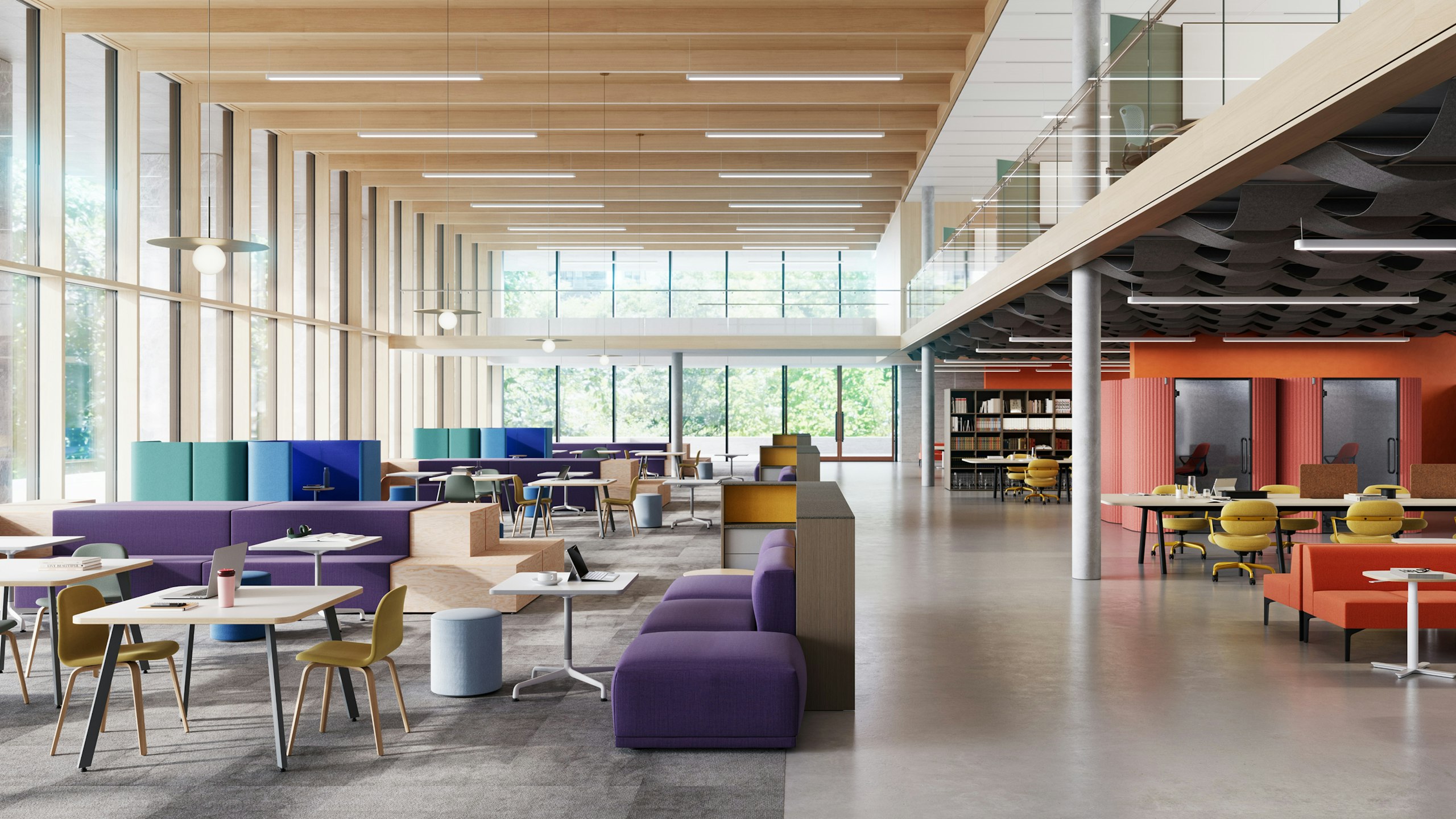 Library/study hall furnished with purple Muuto Connect Modular Sofas, red-orange NaughtOne Symbol sofas, and yellow Knoll Morrison Hannah chairs.