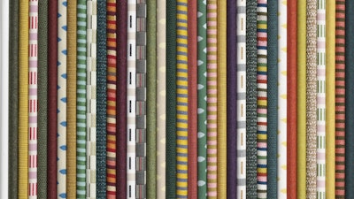 A close-up of a stack of colorful fabric with varying patterns.