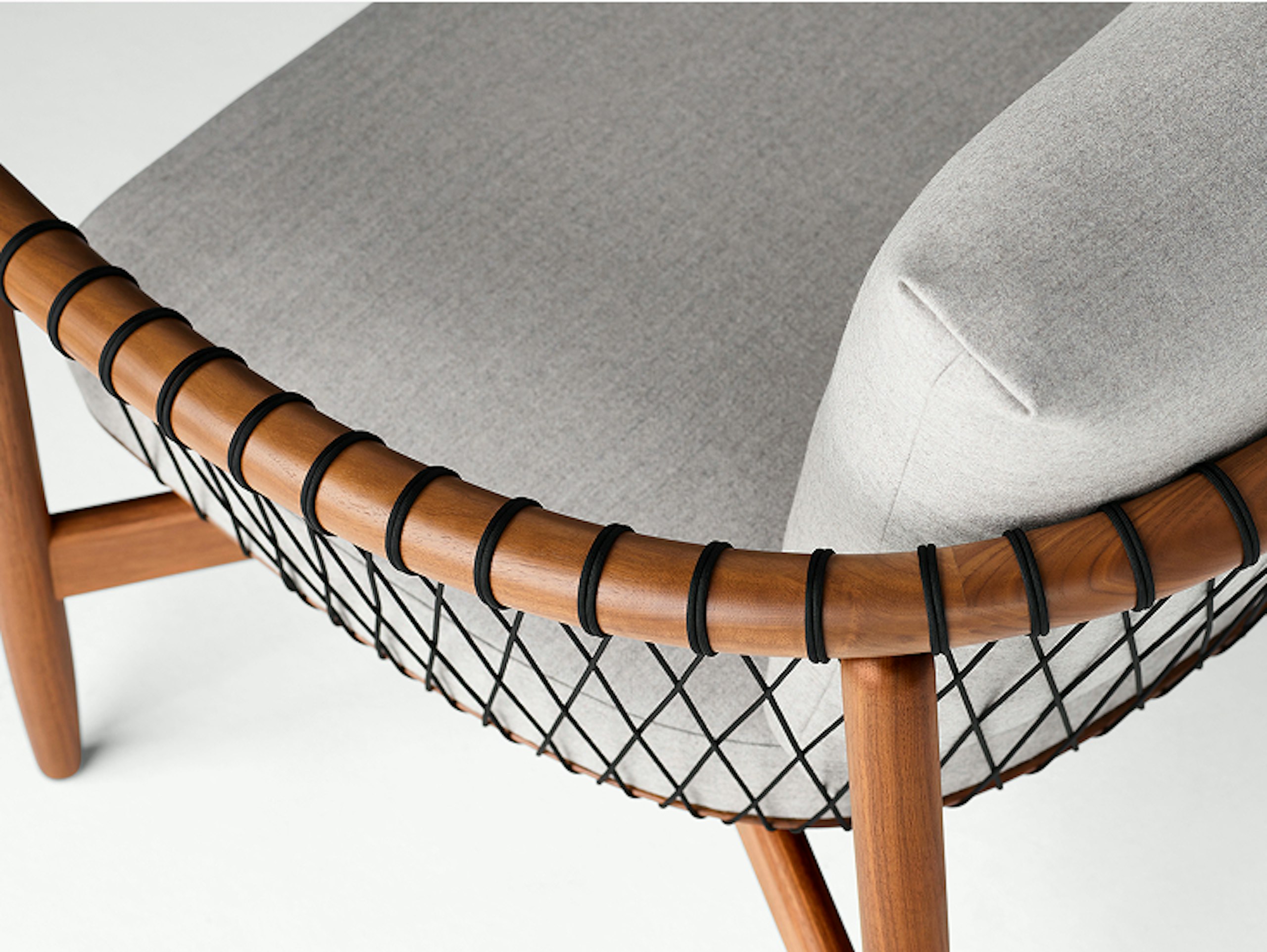A detailed shot of a Crosshatch Settee with a walnut frame, black cords, and light neutral fabric. Viewed from the back at an angle.