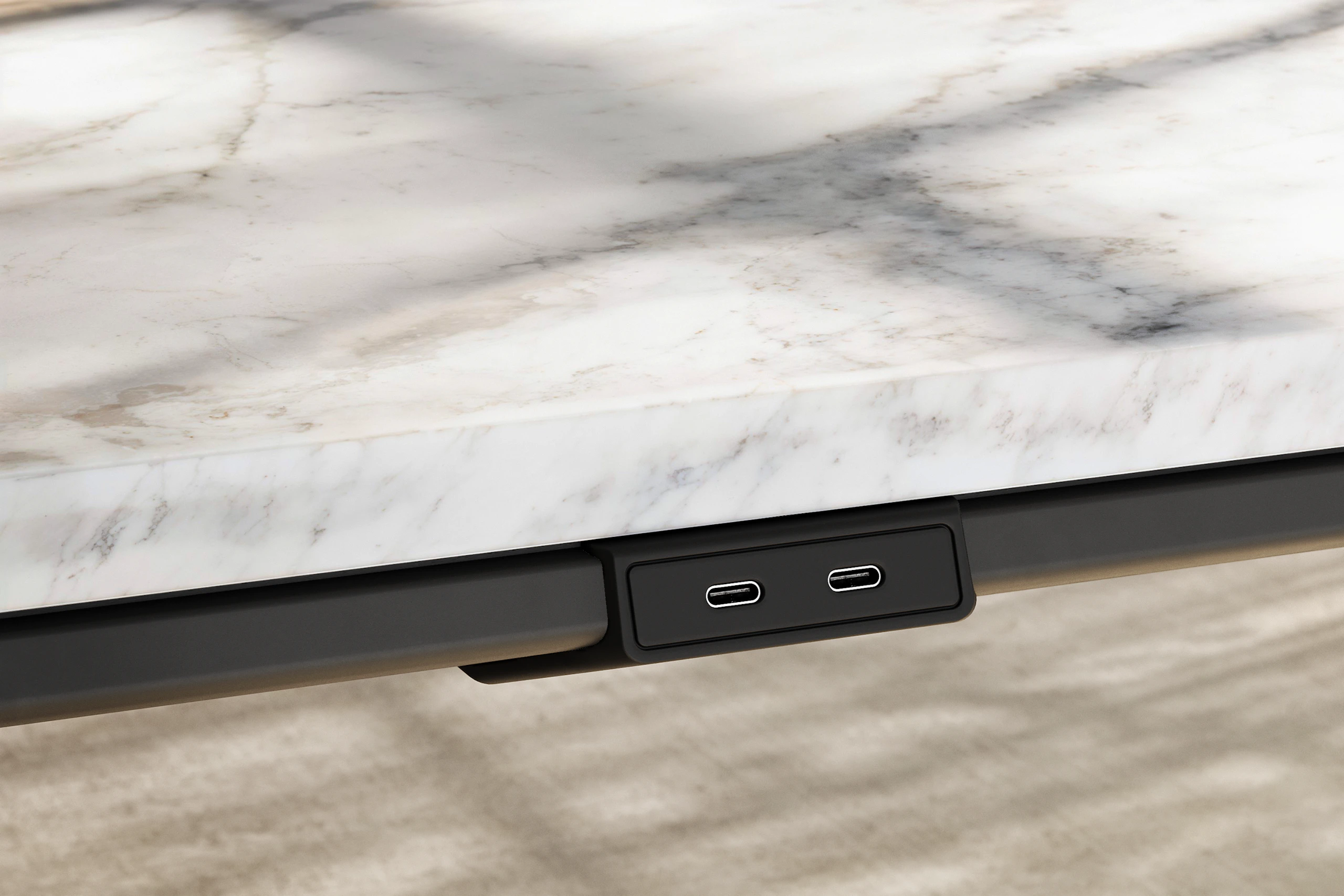 Detail of Ascent Conference Table by EOOS in White Carrara marble showing edge with power access in black viewed at an angle.