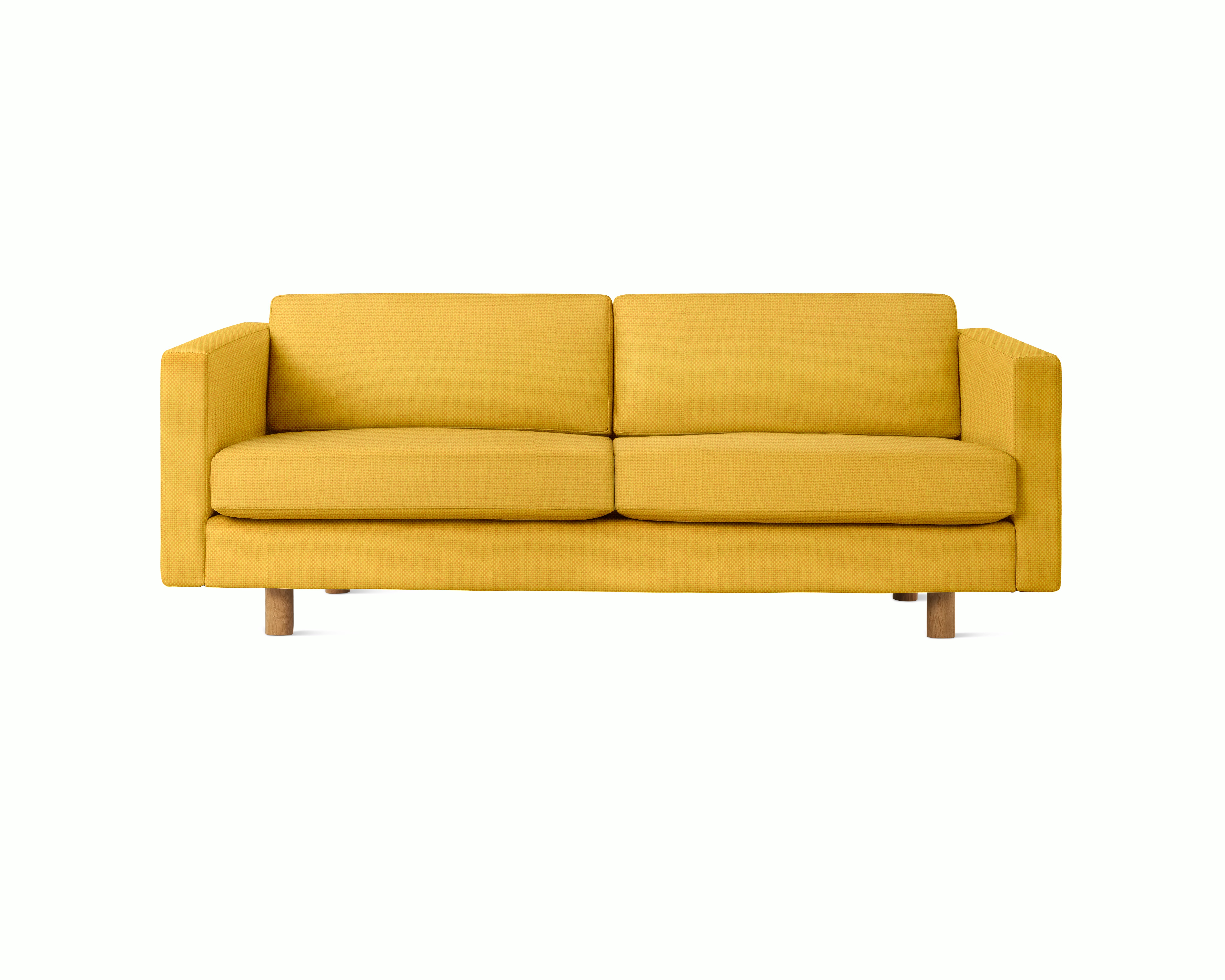 A Lispenard Sofa in Goldenrod upholstery with oak legs viewed from the front.