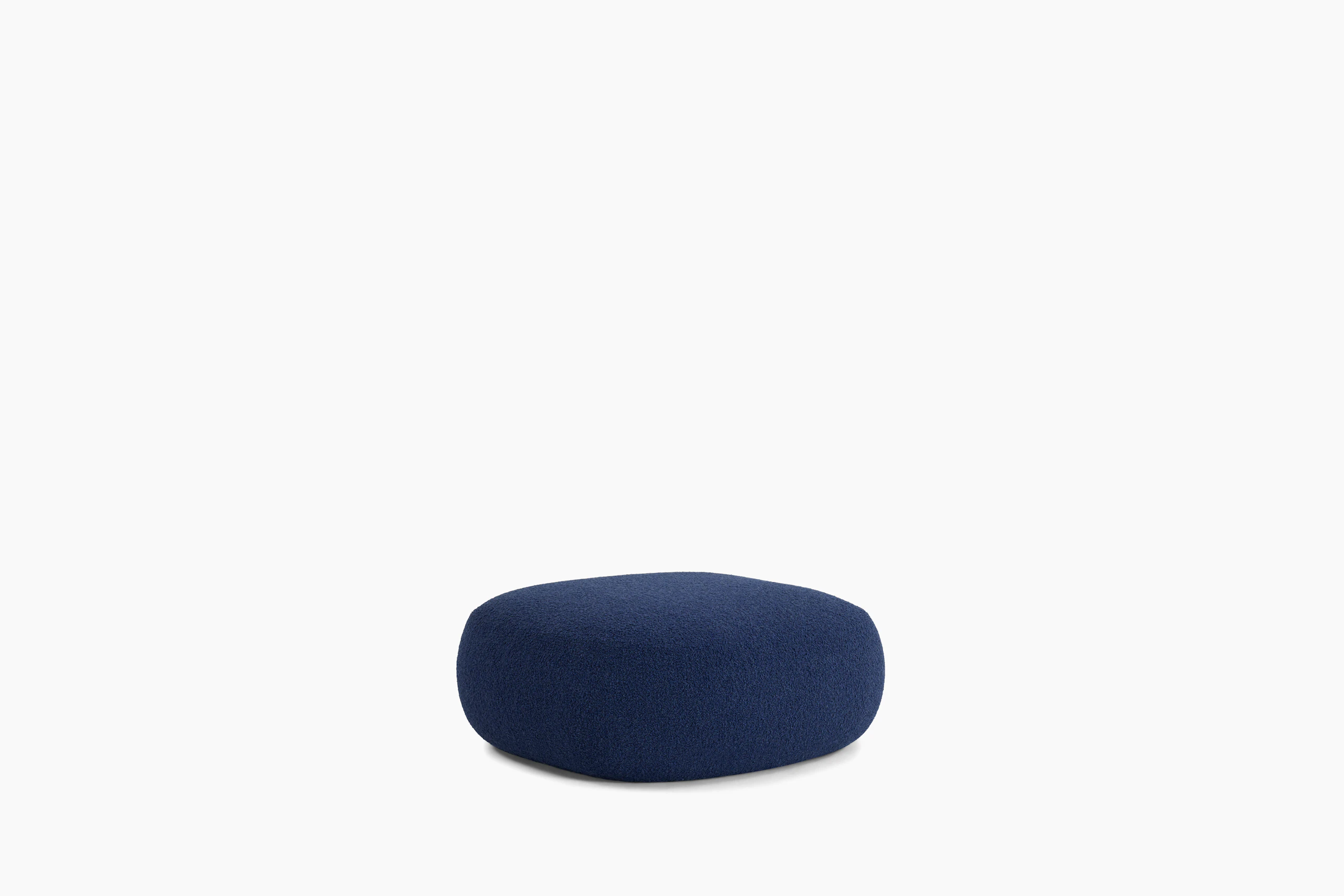 A Biboni Ottoman in Solid Sublime, Navy viewed from an angle.