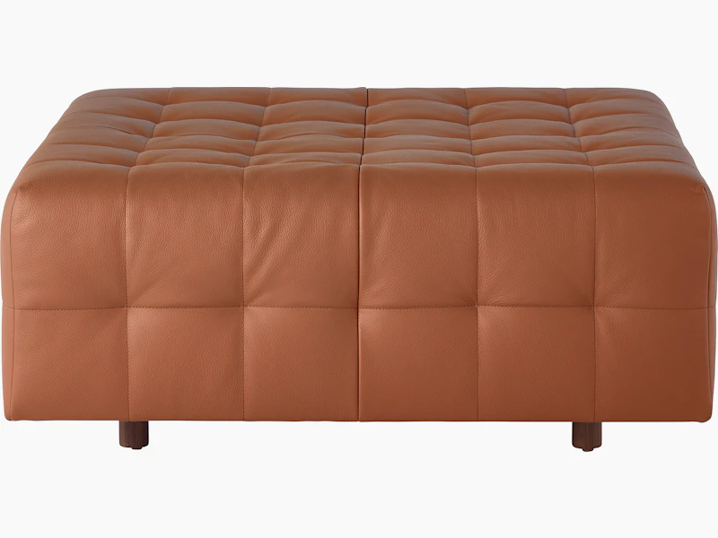 A Rapport ottoman upholstered in leather.