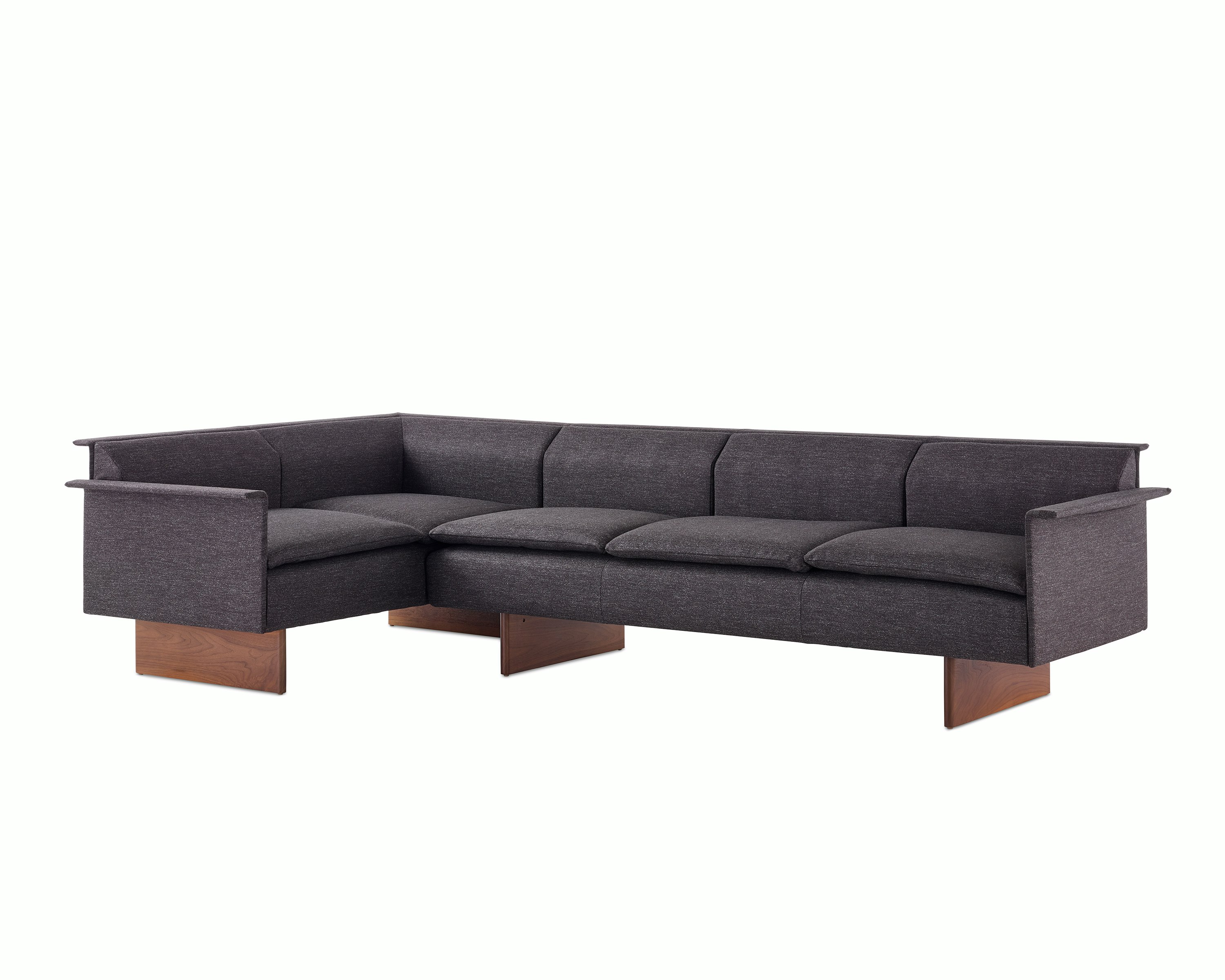 Mantle Sectional Sofa in Bellano Umber with a Walnut Base, viewed at an angle.