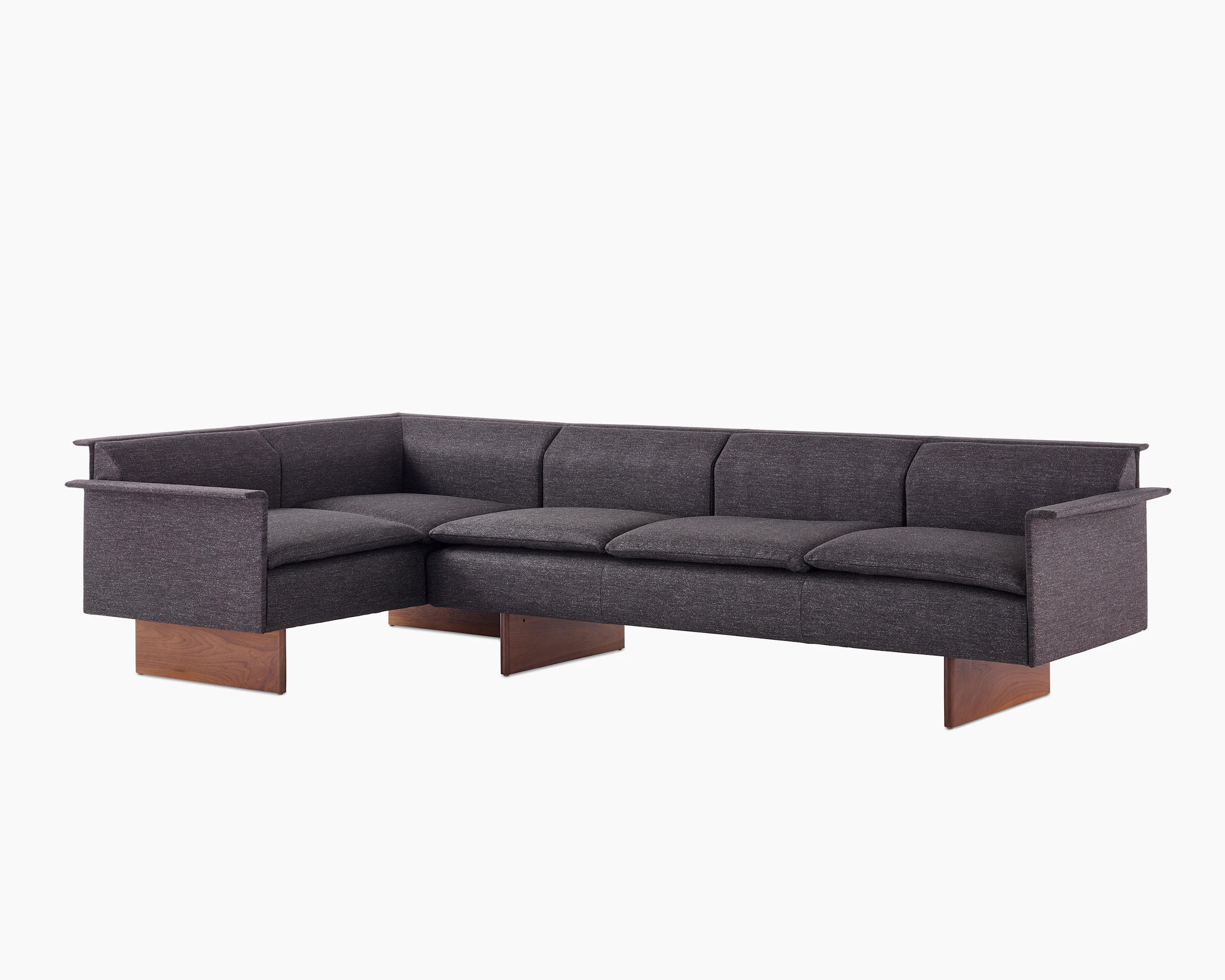 Mantle Sectional Sofa in Bellano Umber with a Walnut Base, viewed at an angle.