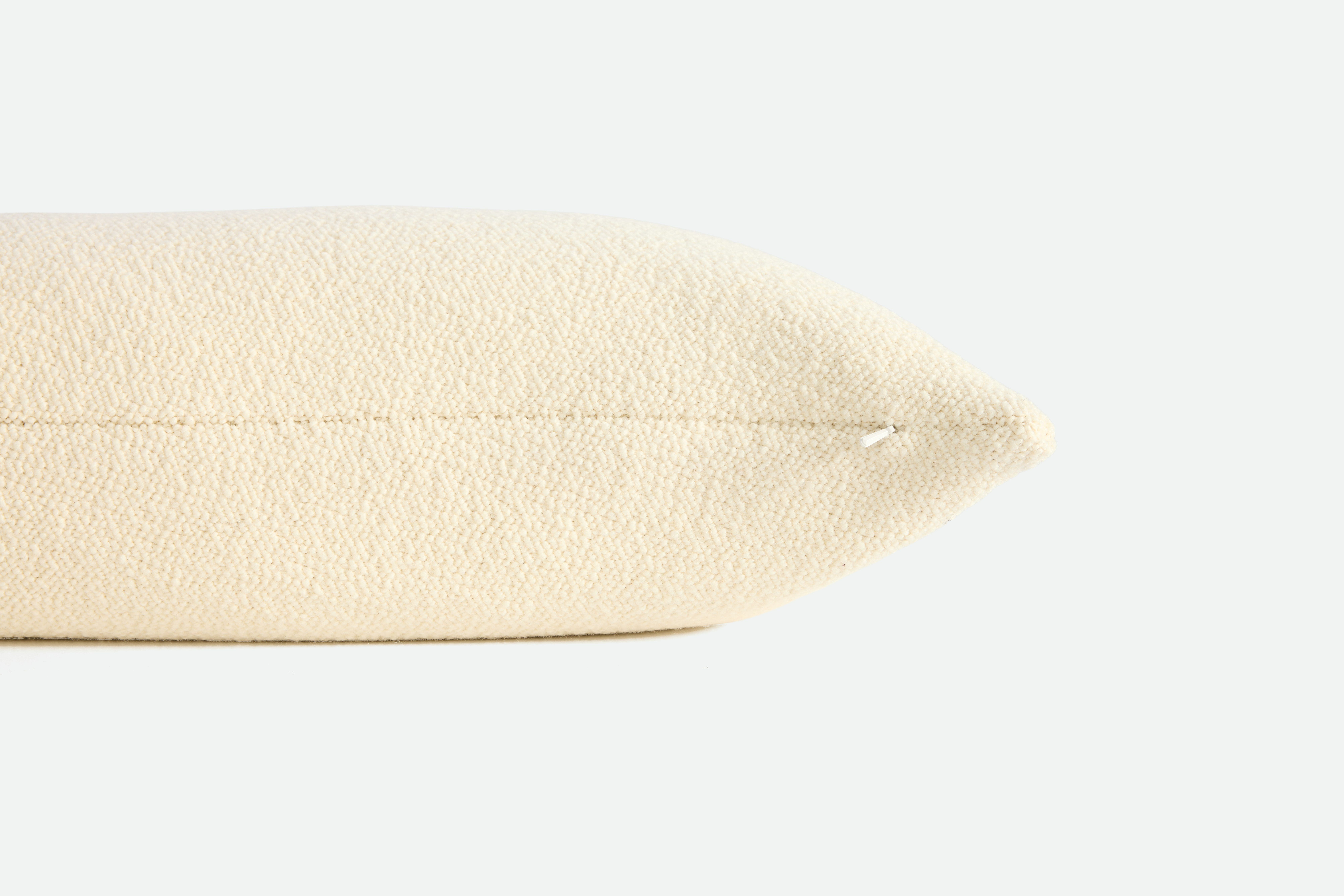 A detailed look at a Turf Boucle Pillow in Cream.