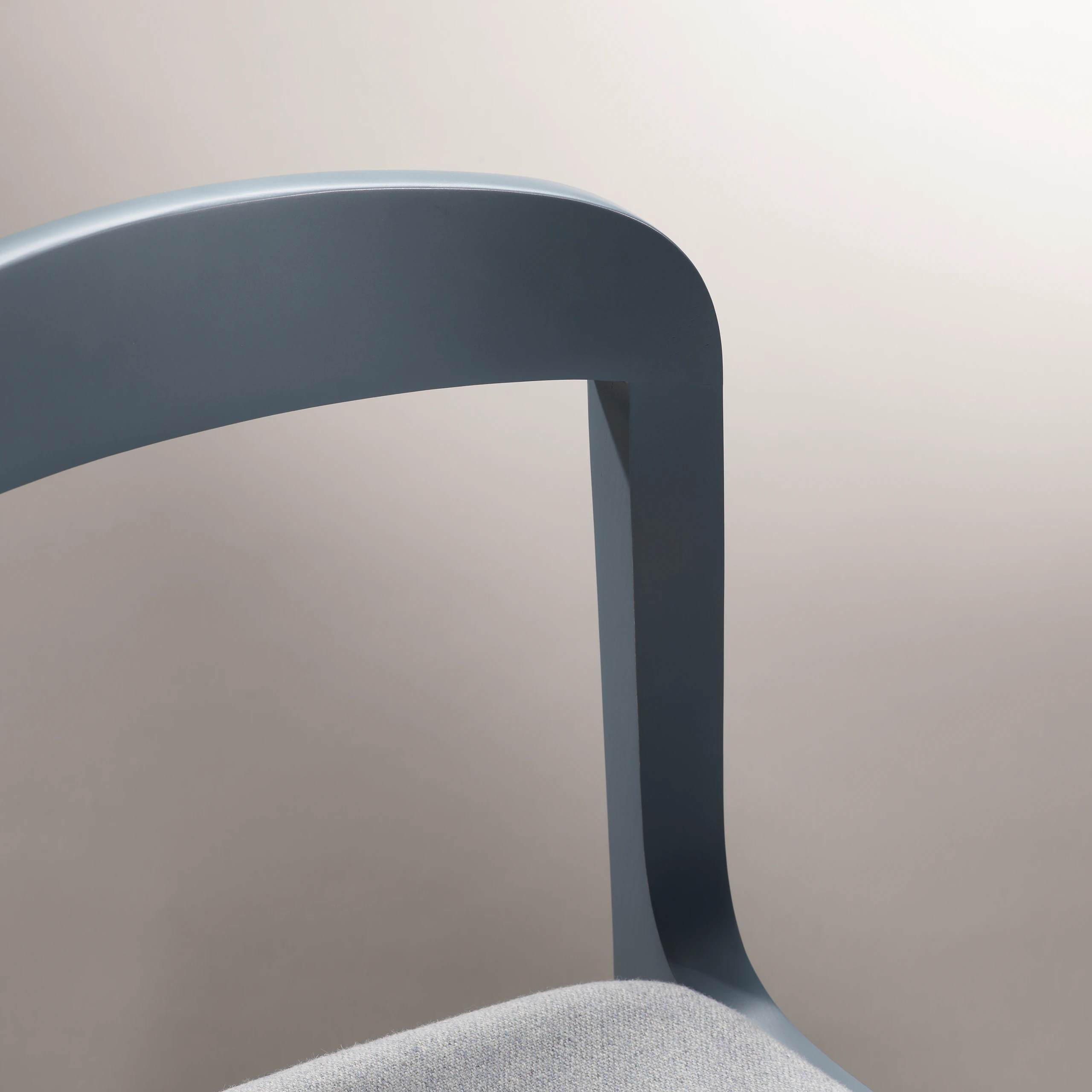 Lijn Side Chair by Carole Baijings for Geiger in Nordic Blue frame upholstered with Maharam Luce in Brine, detail shot on a light background.
