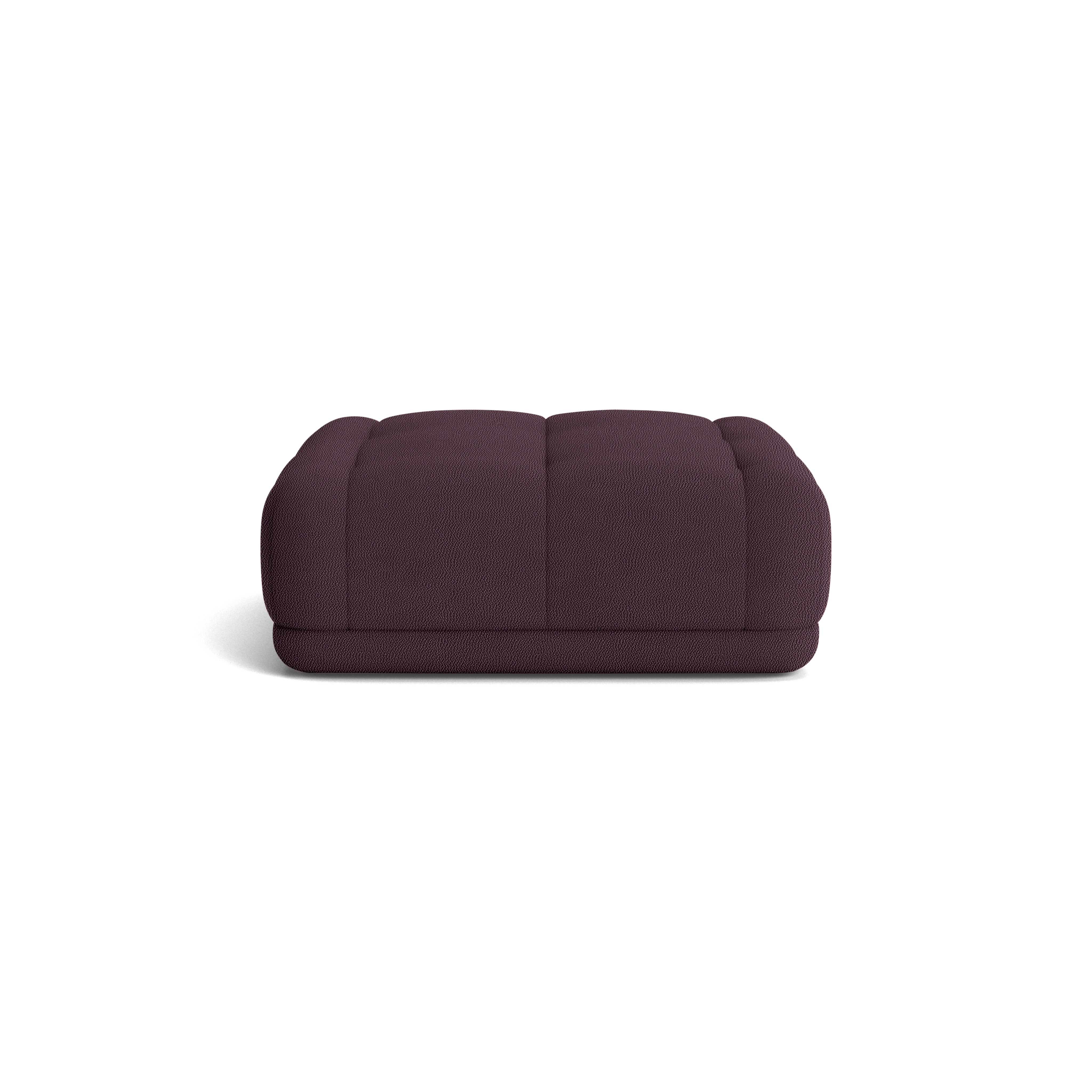 A Quilton Ottoman - Turf, Burgundy in Turf viewed from the front.