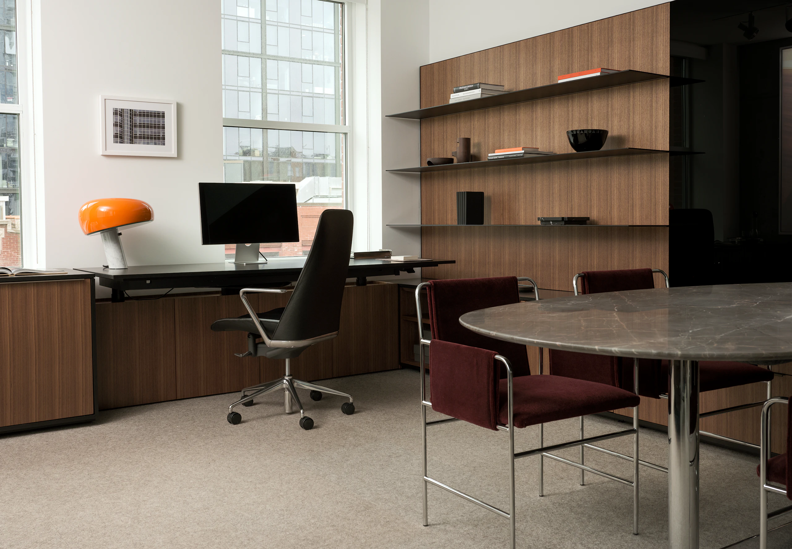 Geiger One Private Office in Natural Quarter Cut Walnut with a Taper Chair, MP Table, and two Envelope Chairs, viewed at an angle.