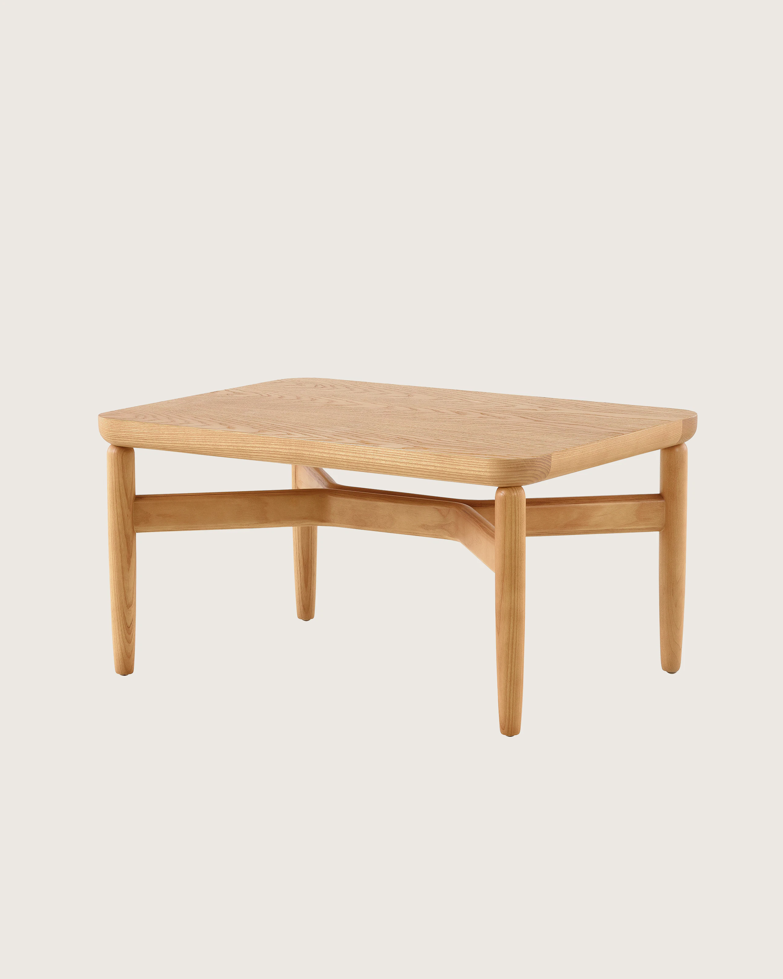 A Reframe Rectangular Table in Rift Oak, viewed from a three-quarter perspective.
