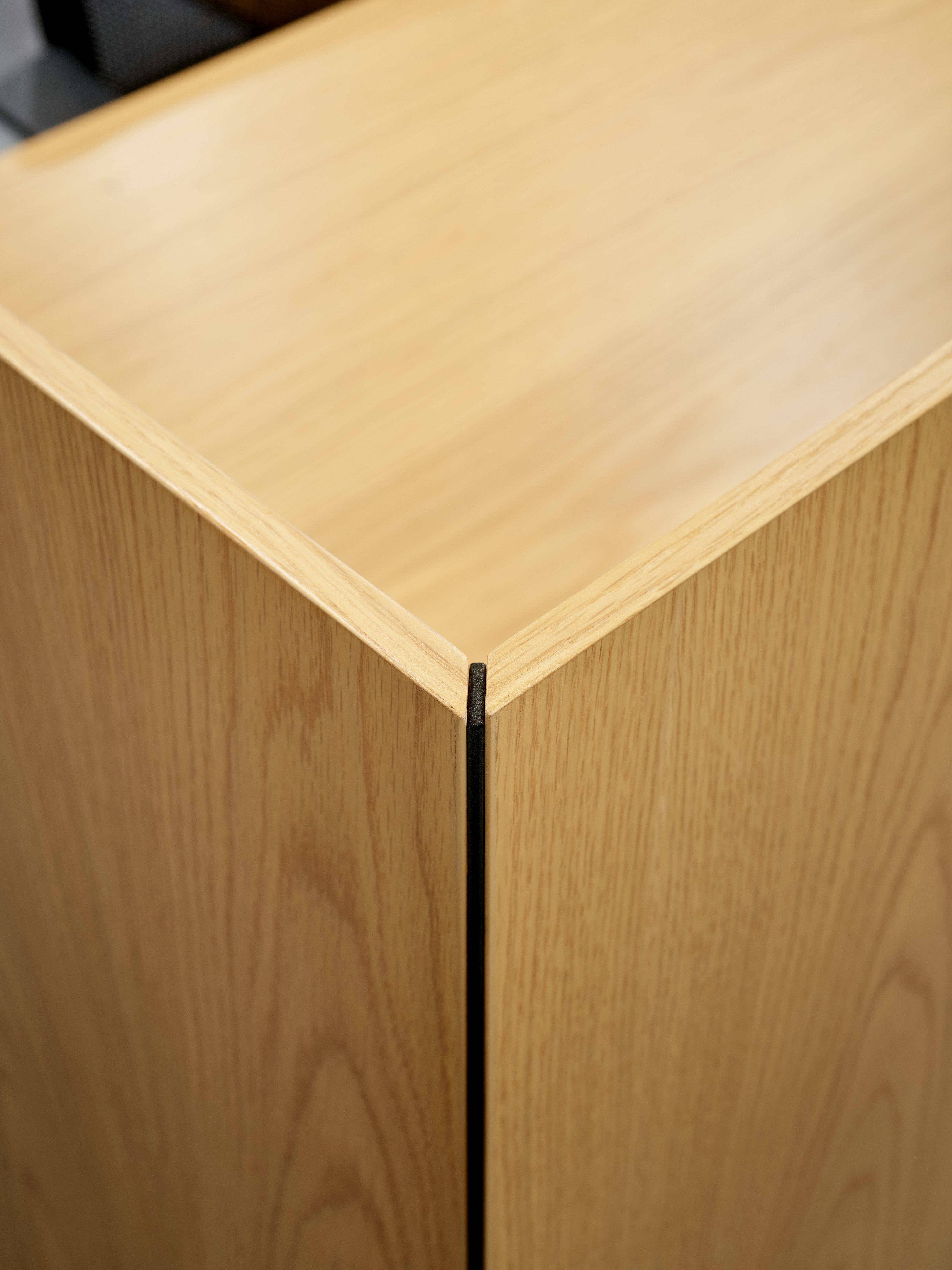 A mitered edge detail of a freestanding or surface attached screen is viewed close up and at an angle.