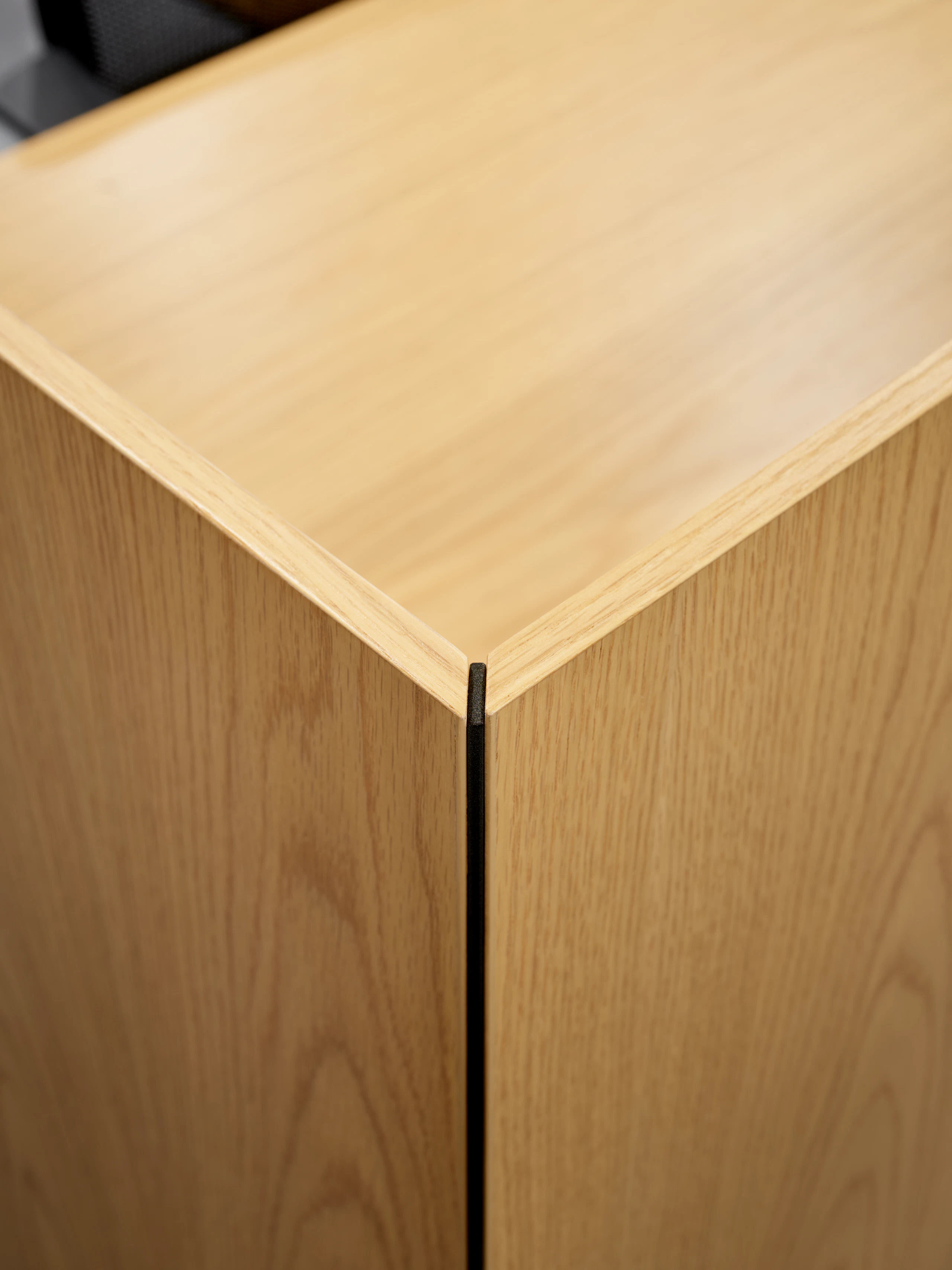 A mitered edge detail of a freestanding or surface attached screen is viewed close up and at an angle.