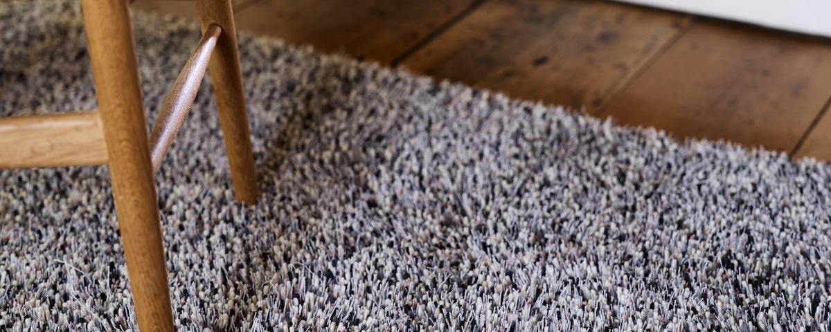 Closeup image of Tekla Rug and WIshbone Chair