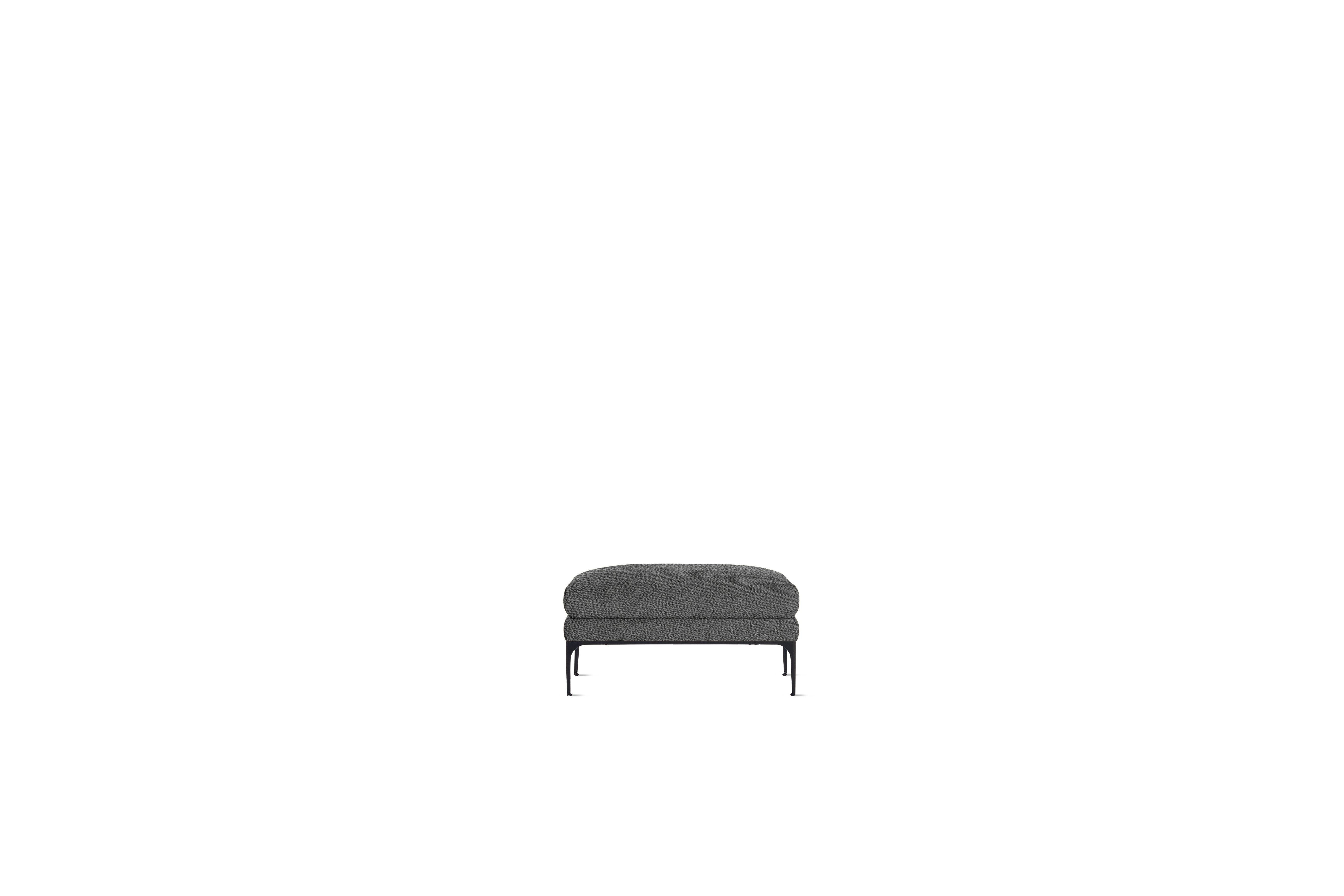 A Jonas Ottoman in Turf, Grey with Black finish viewed from the front.