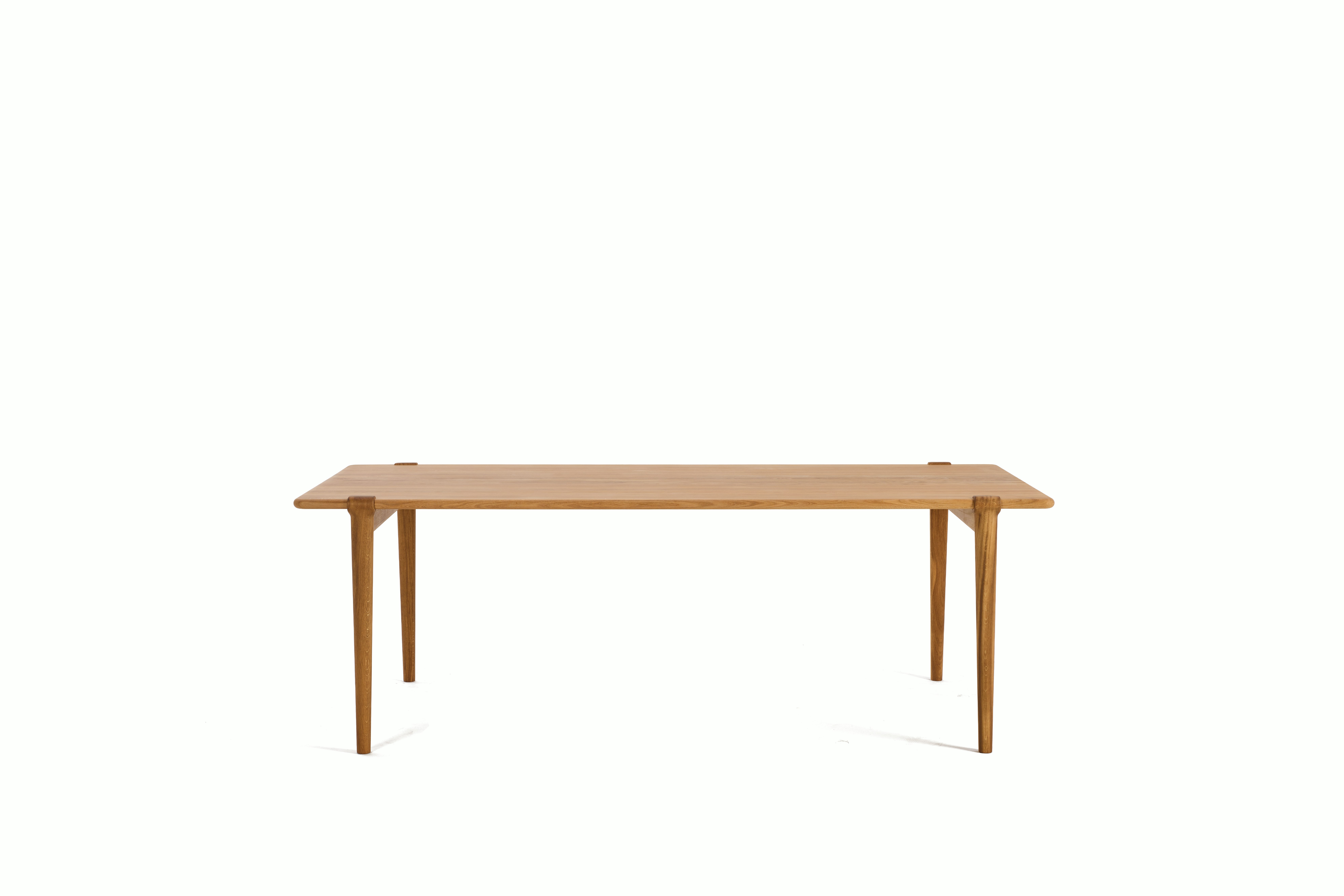An Otto Dining Table in Oak viewed from the front.