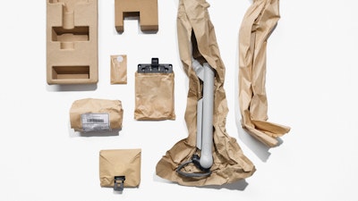 An overhead view of brown packaging components, some containing product parts.
