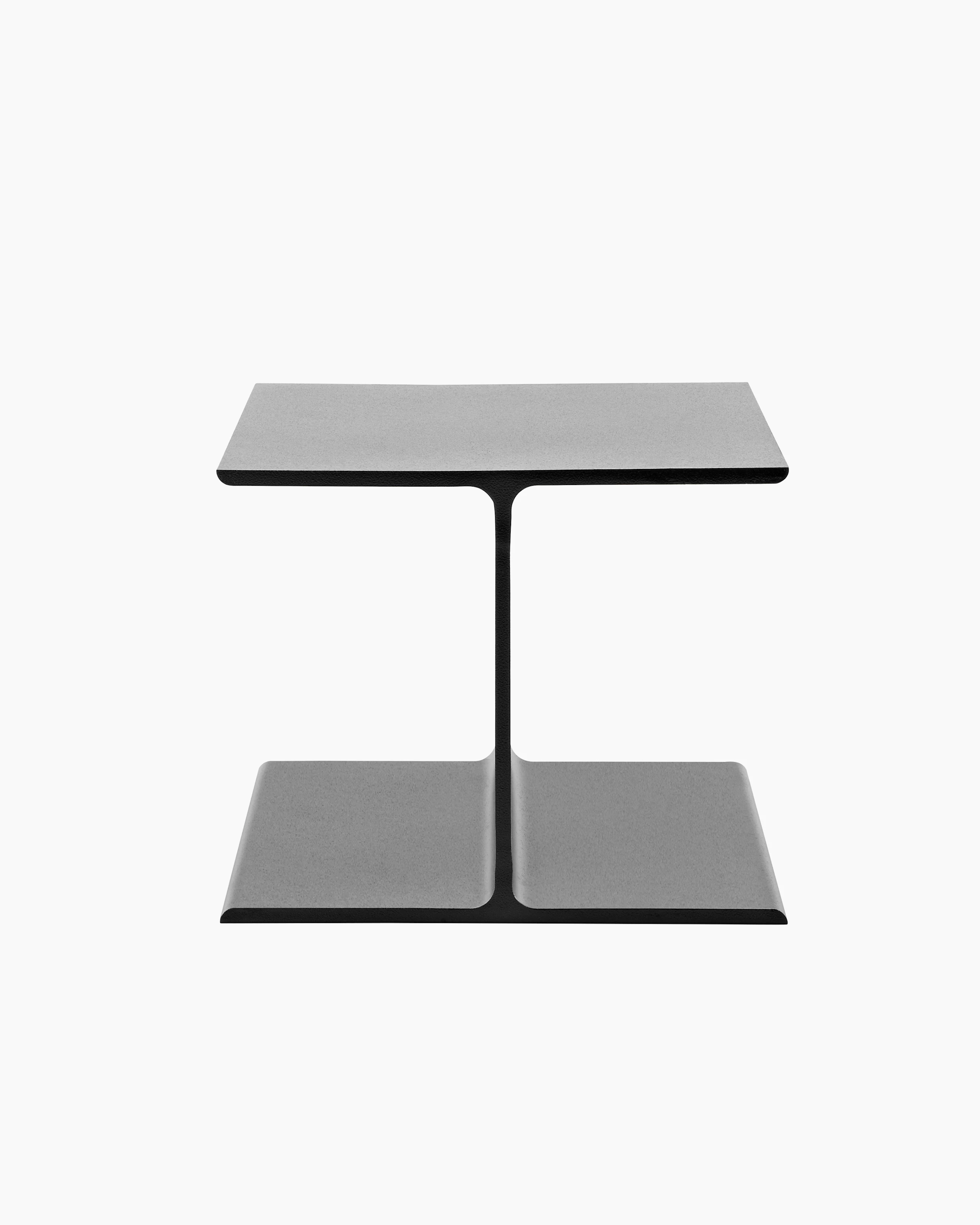 A black I Beam side table, oriented to display the upper and lower flanges of the cast-aluminum pedestal.