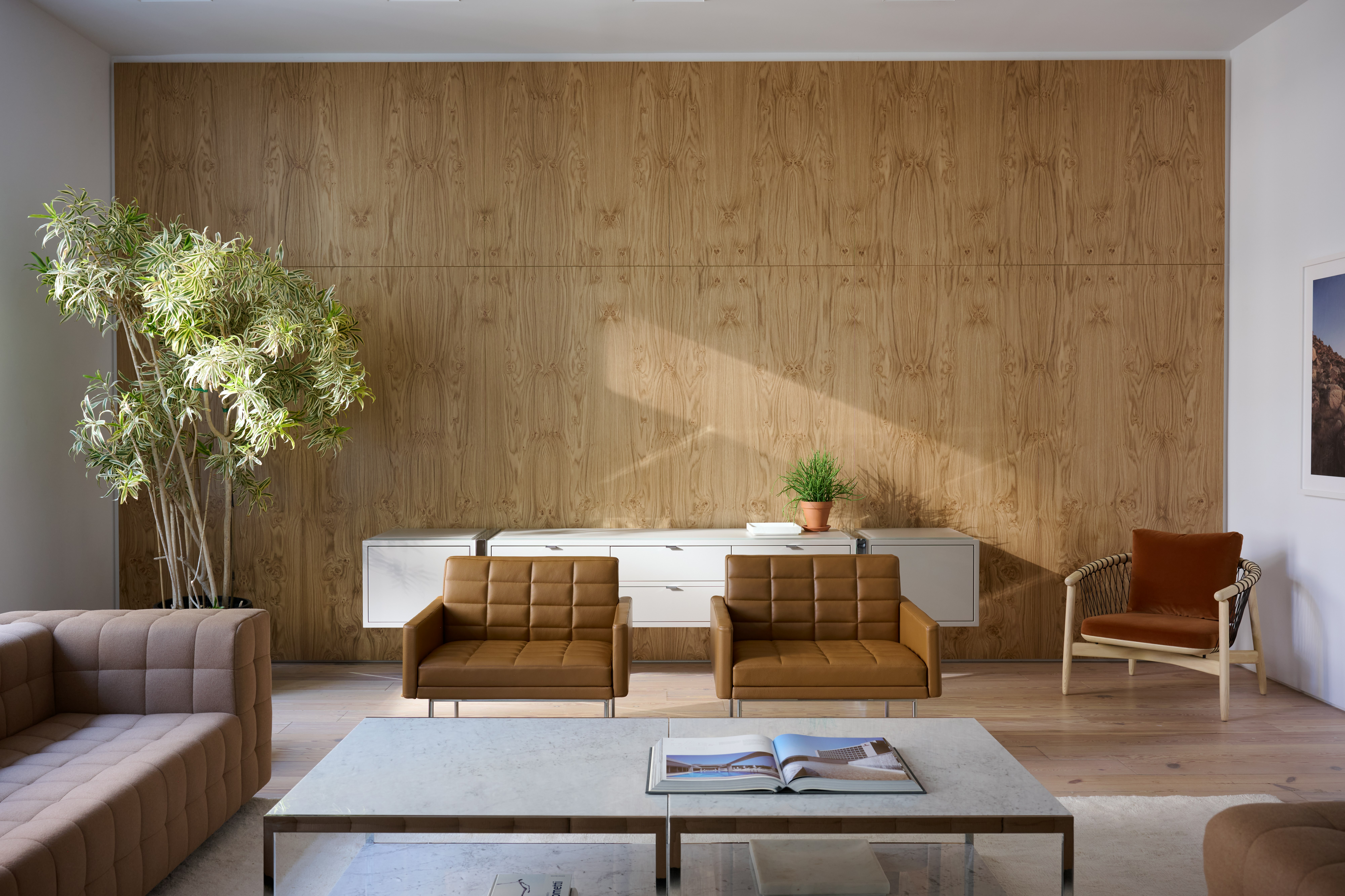 Lounge setting with a Rapport Sectional Sofa, and Tuxedo Component Club Chairs around two H-Frame Coffee Tables with a Highline Credenza and Crosshatch Lounge Chair.
