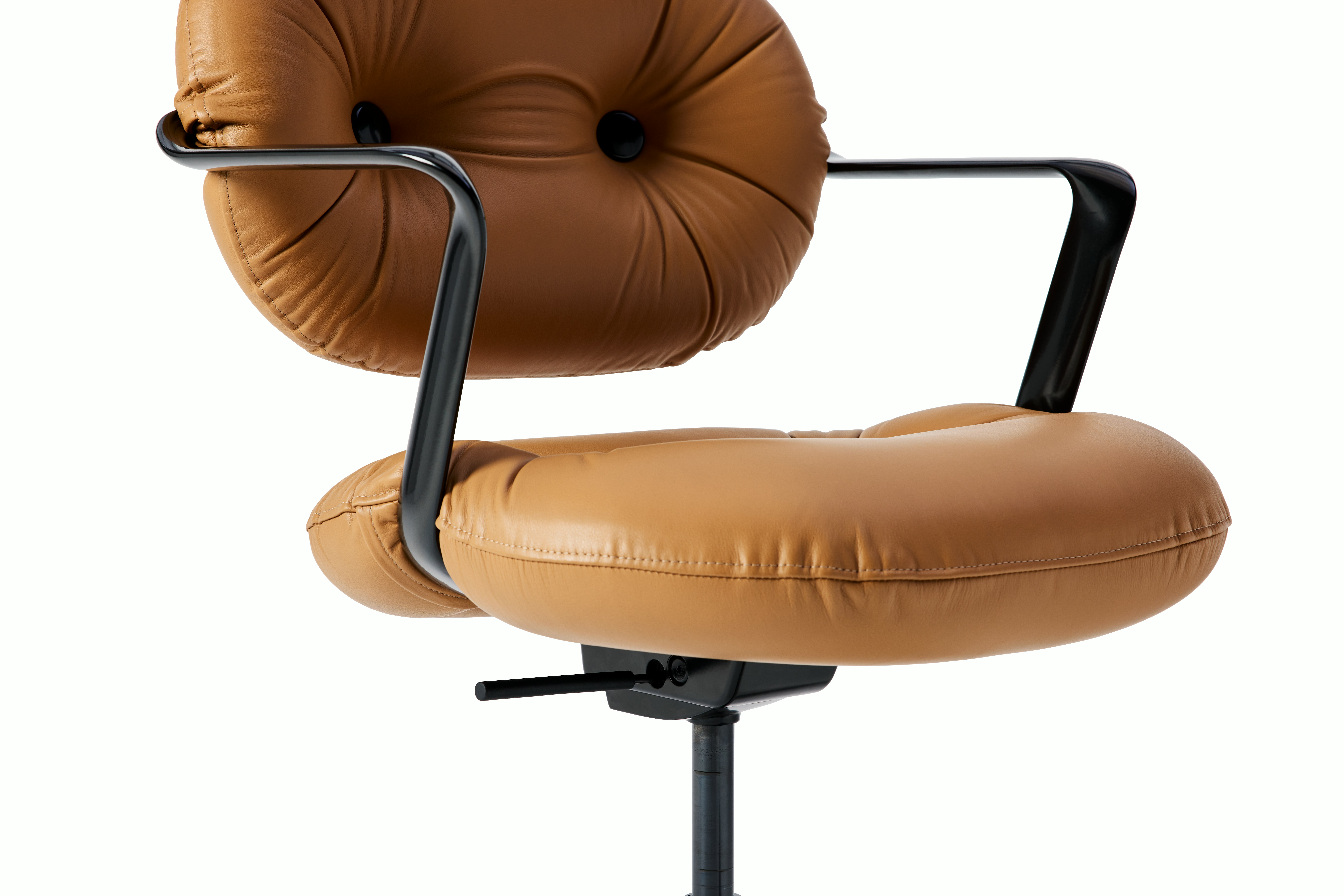 Detail view of a Morrison Hannah chair with a black frame and base with fixed arms and light brown leather upholstery.