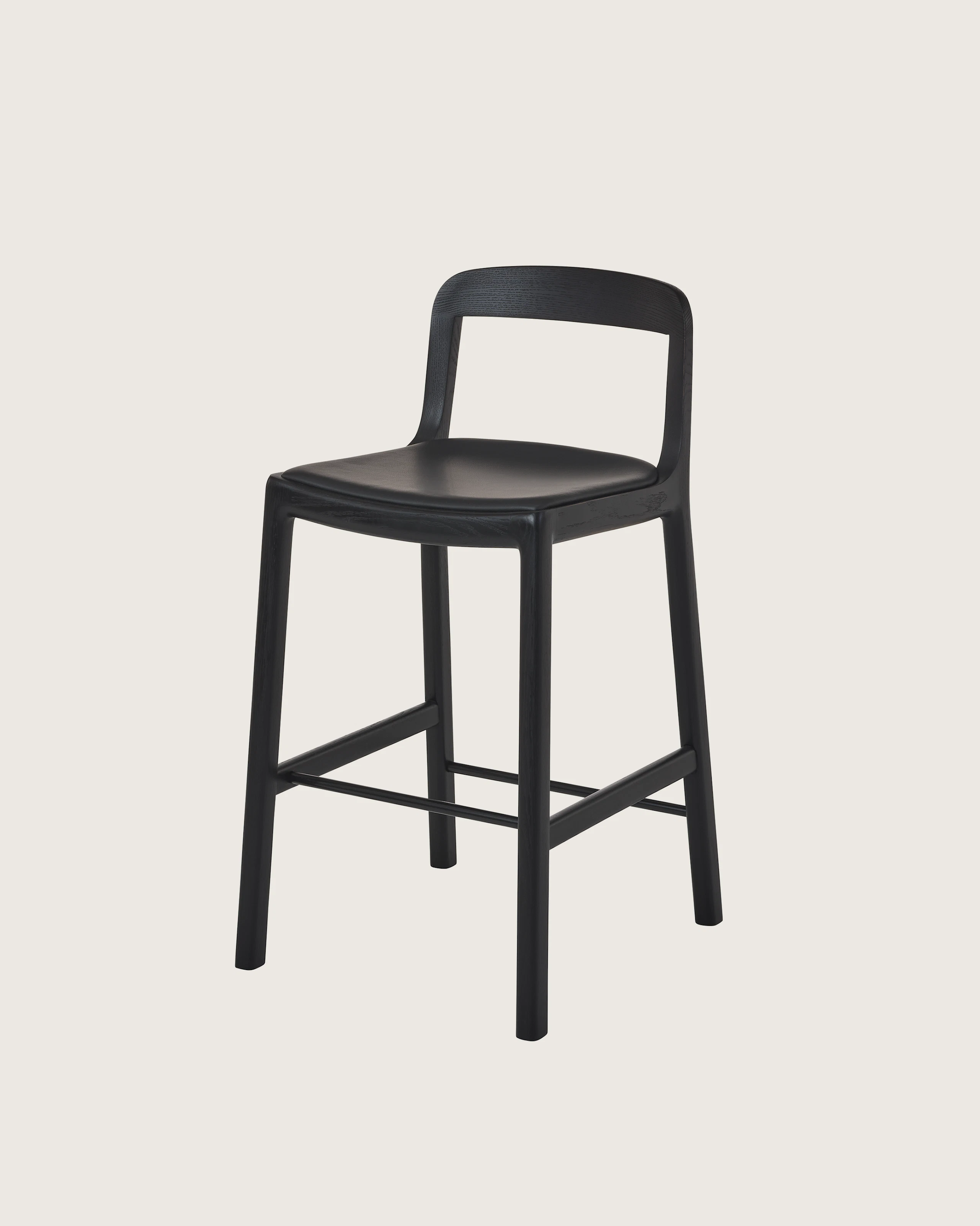 Lijn Stool by Carole Baijings for Geiger in Ebonized Oak frame upholstered with Maharam Prone Leather in Obsidian, angled front view on a white sweep.