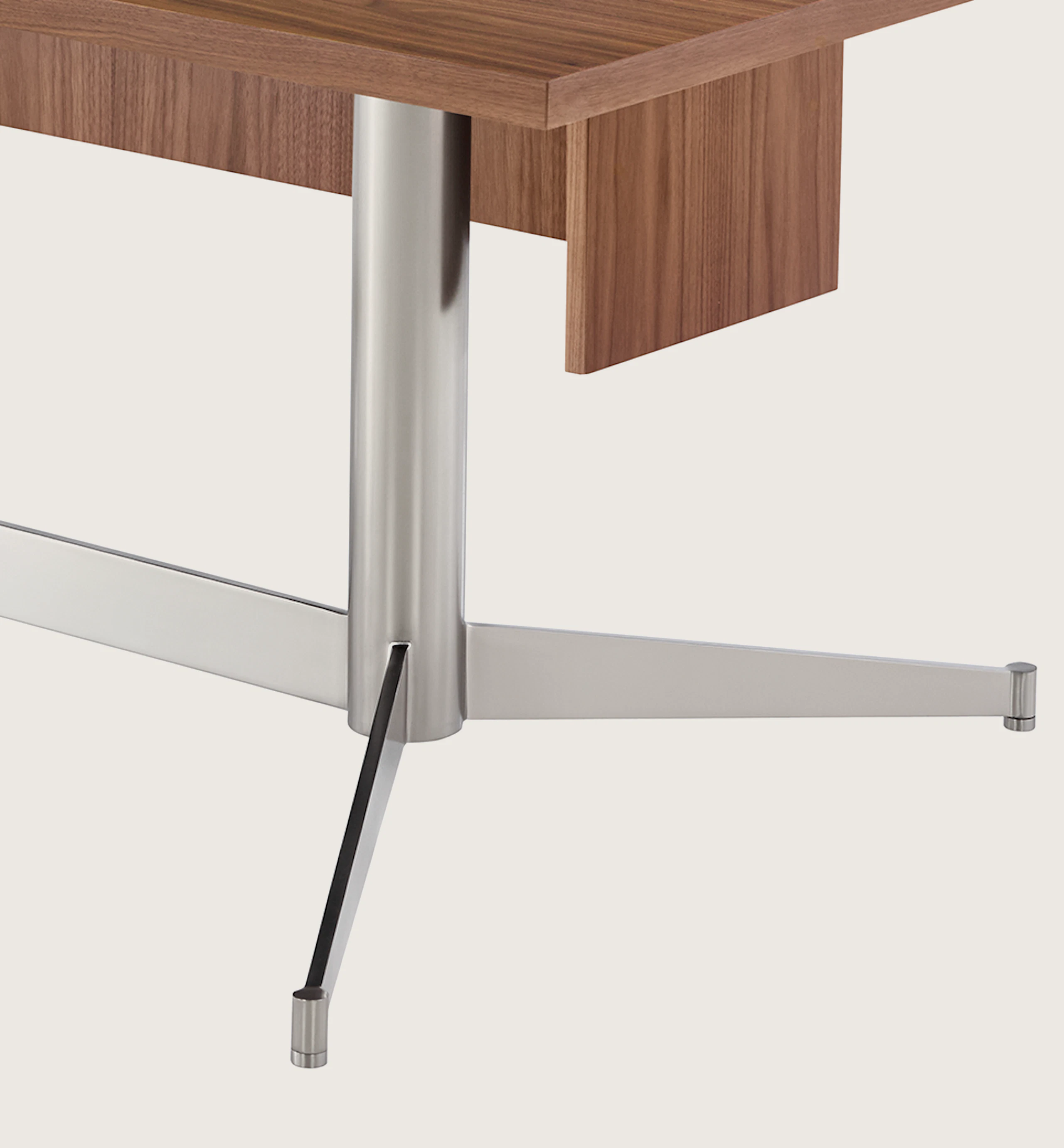 A rectangular MP Height-Adjustable Table in the seated position, viewed from an angle and showing the height-adjustment button beneath the tabletop.