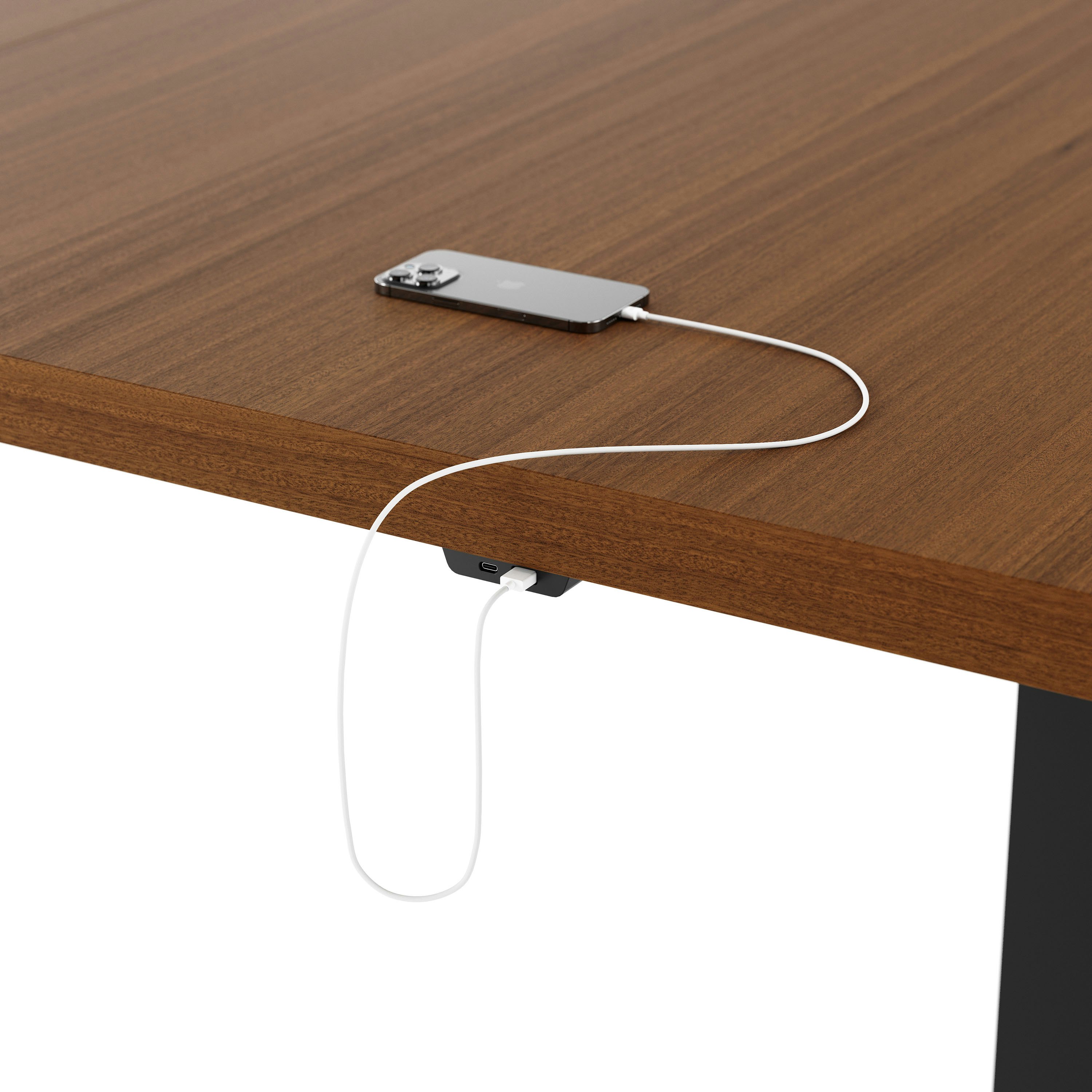 Detail shot of undermount power access on a rectangular JD Conference Table with a Natural Quarter Cut Walnut tabletop and Black base.