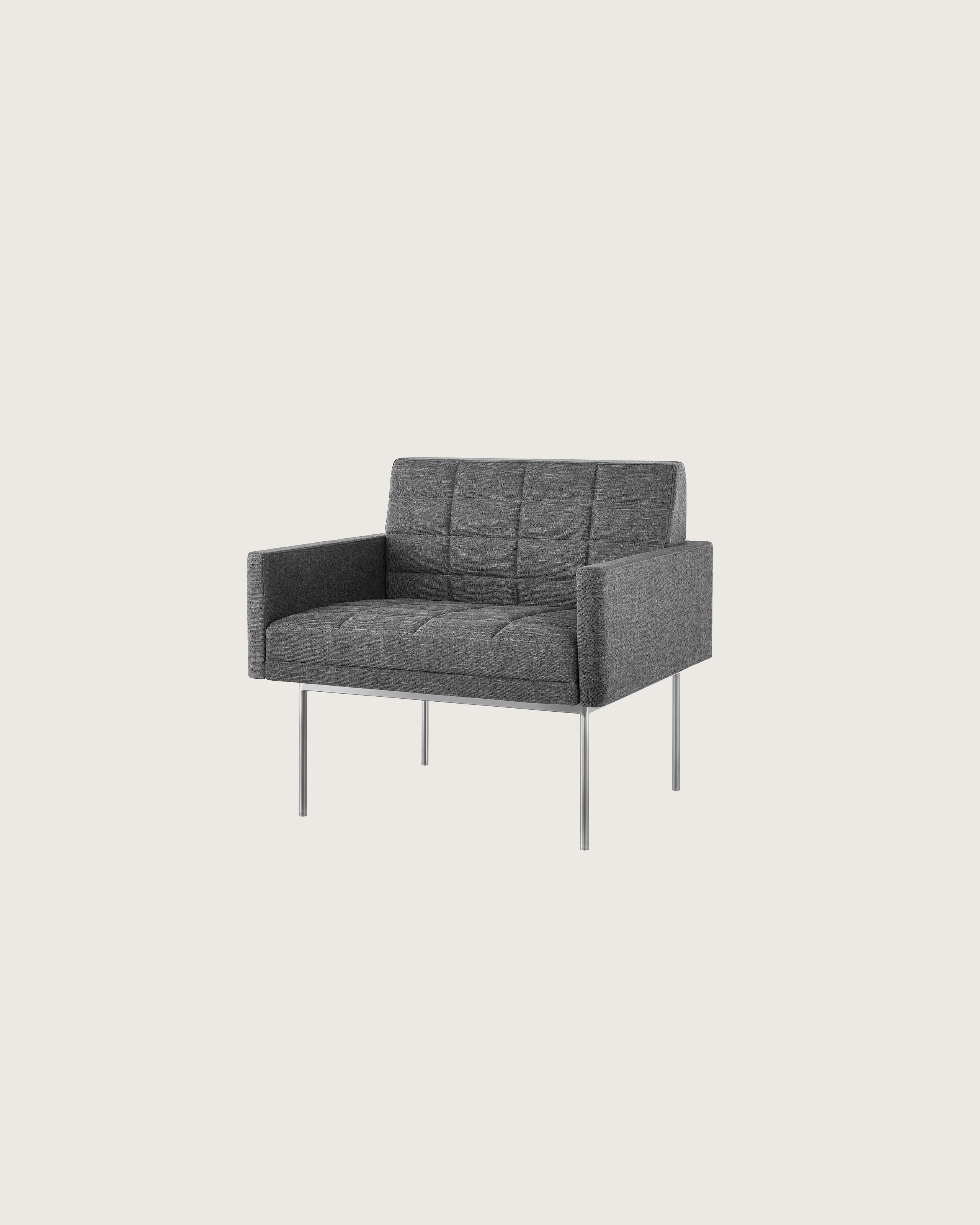 A quilted Tuxedo Component Club Chair with medium gray upholstery and a metal base, viewed at an angle.