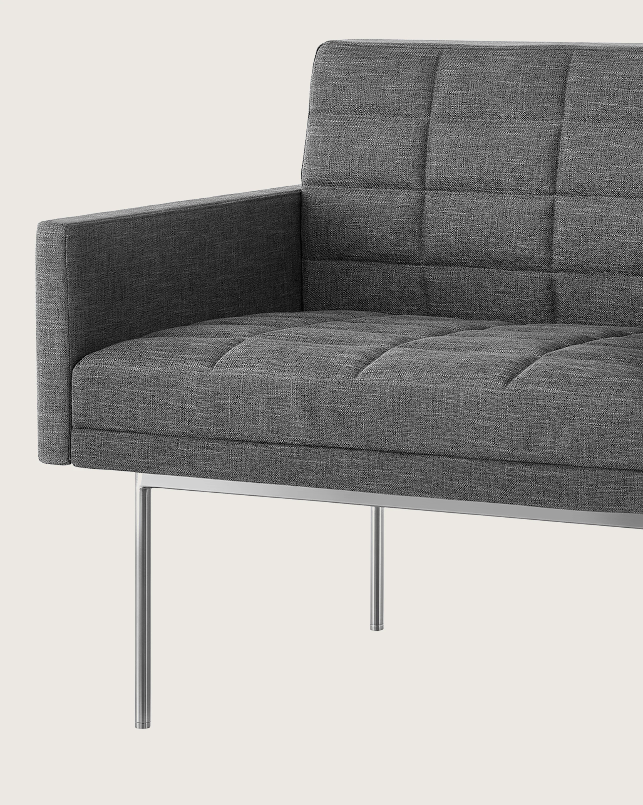 A quilted Tuxedo Component Club Chair with medium gray upholstery and a metal base, viewed at an angle.