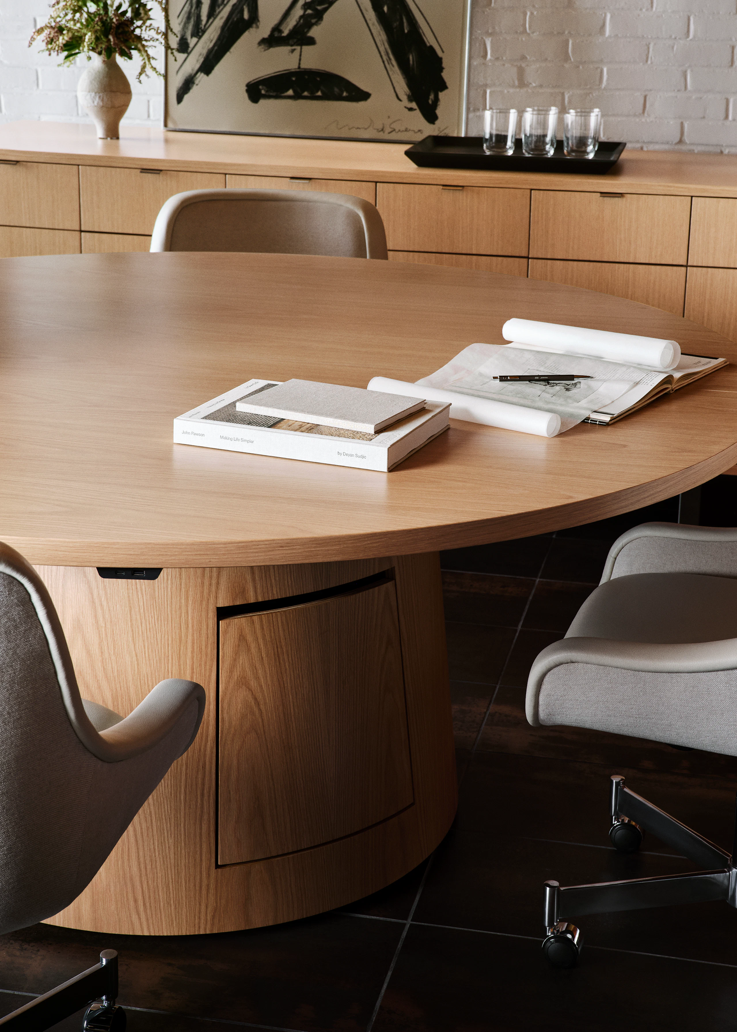 JD Meeting Table in natural flat cut oak shown surrounded by Bumper Chairs in front of a Highline 25 Credenza.