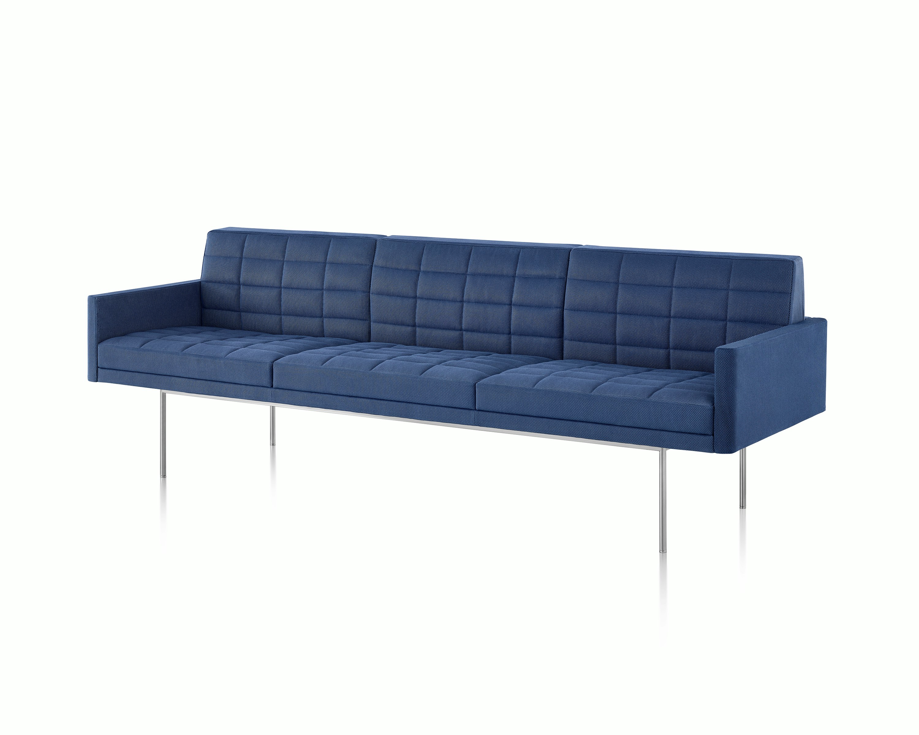 Angled view of a quilted Tuxedo Component sofa upholstered in blue fabric.