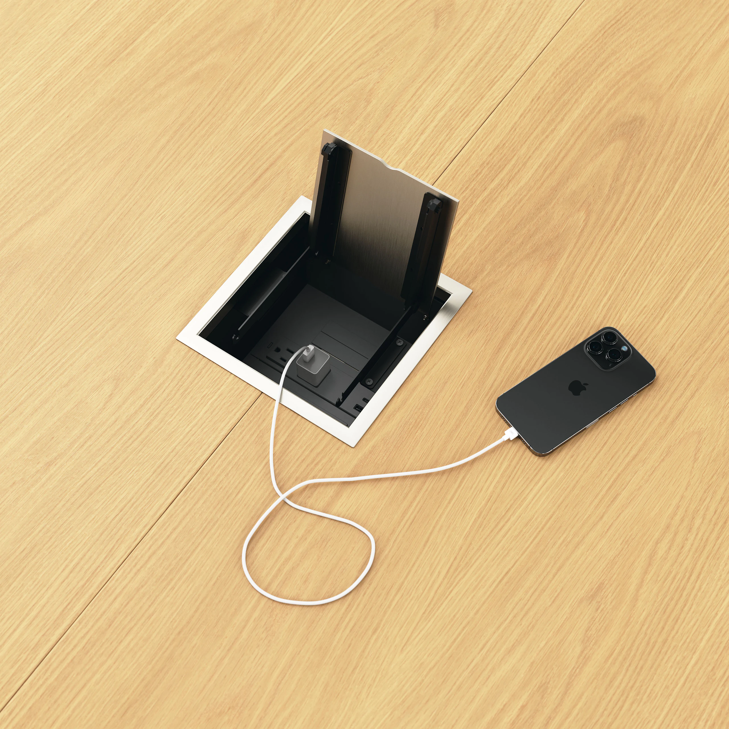 Detail shot of open tabletop power access on a Circular Highline Meeting Table in Natural Flat Cut Oak and Satin Nickel.