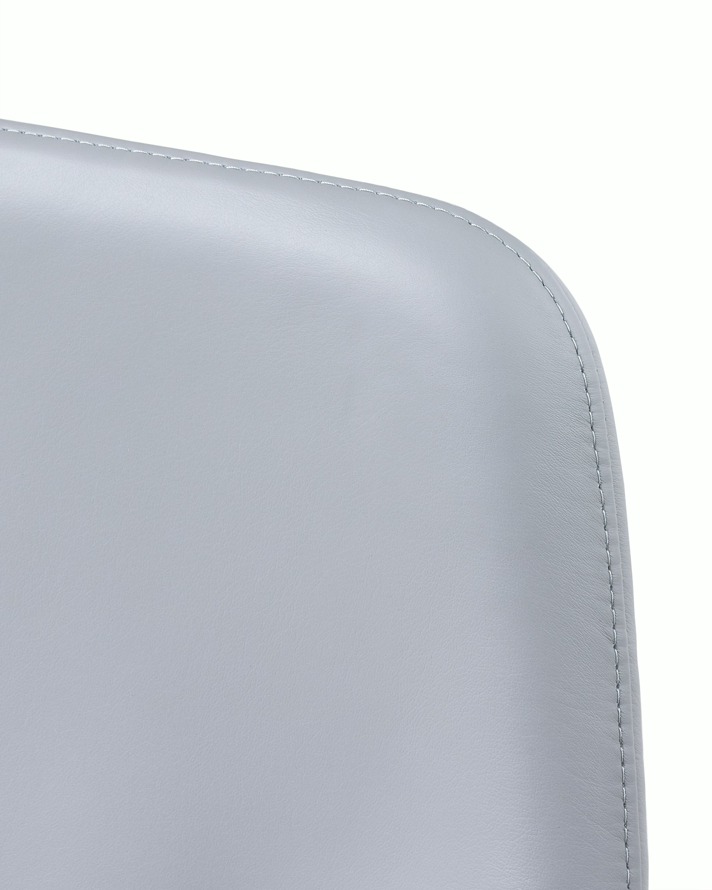 Close-up of an upper corner on the back of a Taper office chair, showing the single stitch option.