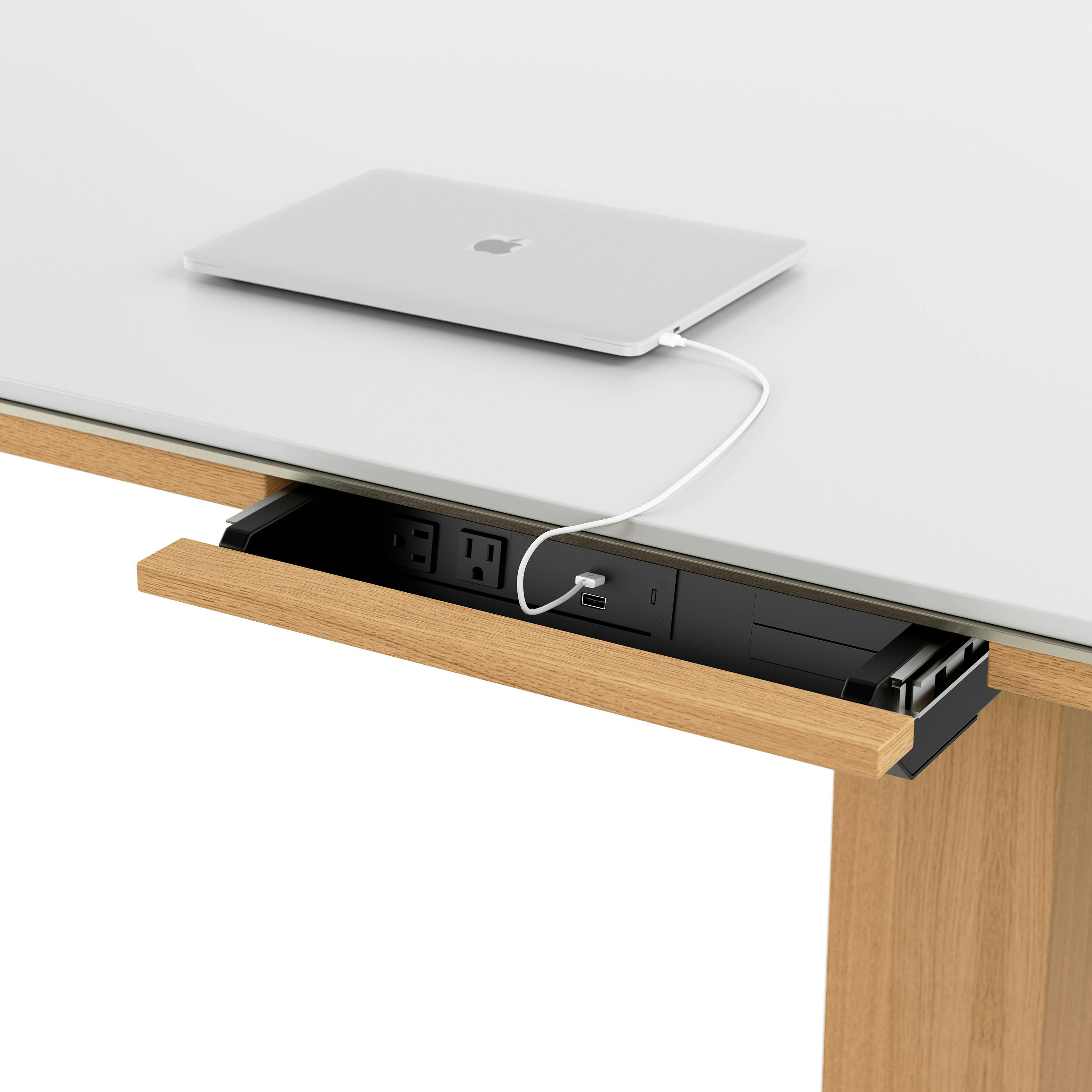 Detail shot of open power drawer on Highline Fifty Conference Table in Glacier White Corian and Natural Rift Cut Oak viewed from an angle.