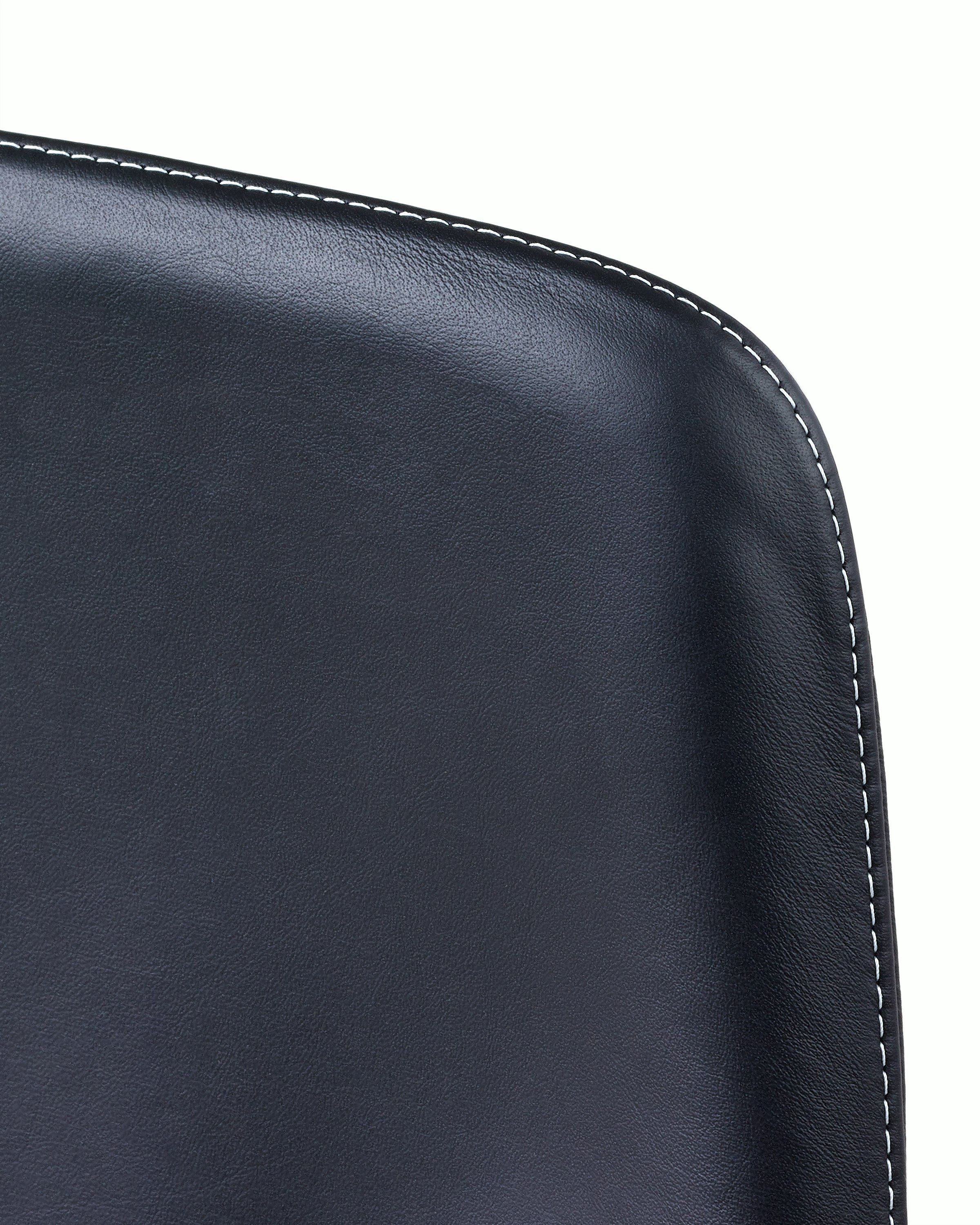 Close-up of an upper corner on the back of a Taper office chair, showing the single stitch option with constrasting thread.