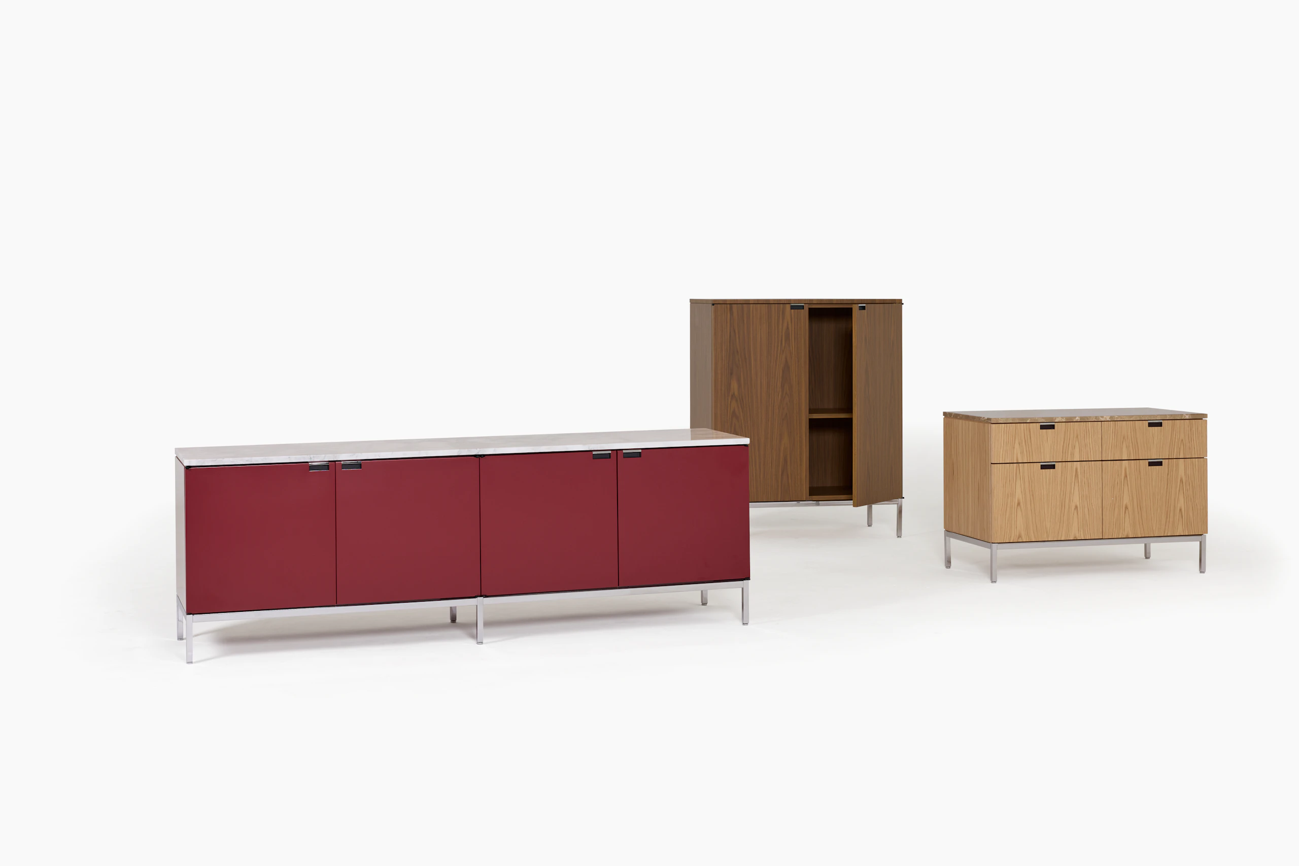 Three Florence Knoll Credenzas in various sizes with red, dark brown, and light brown cases.