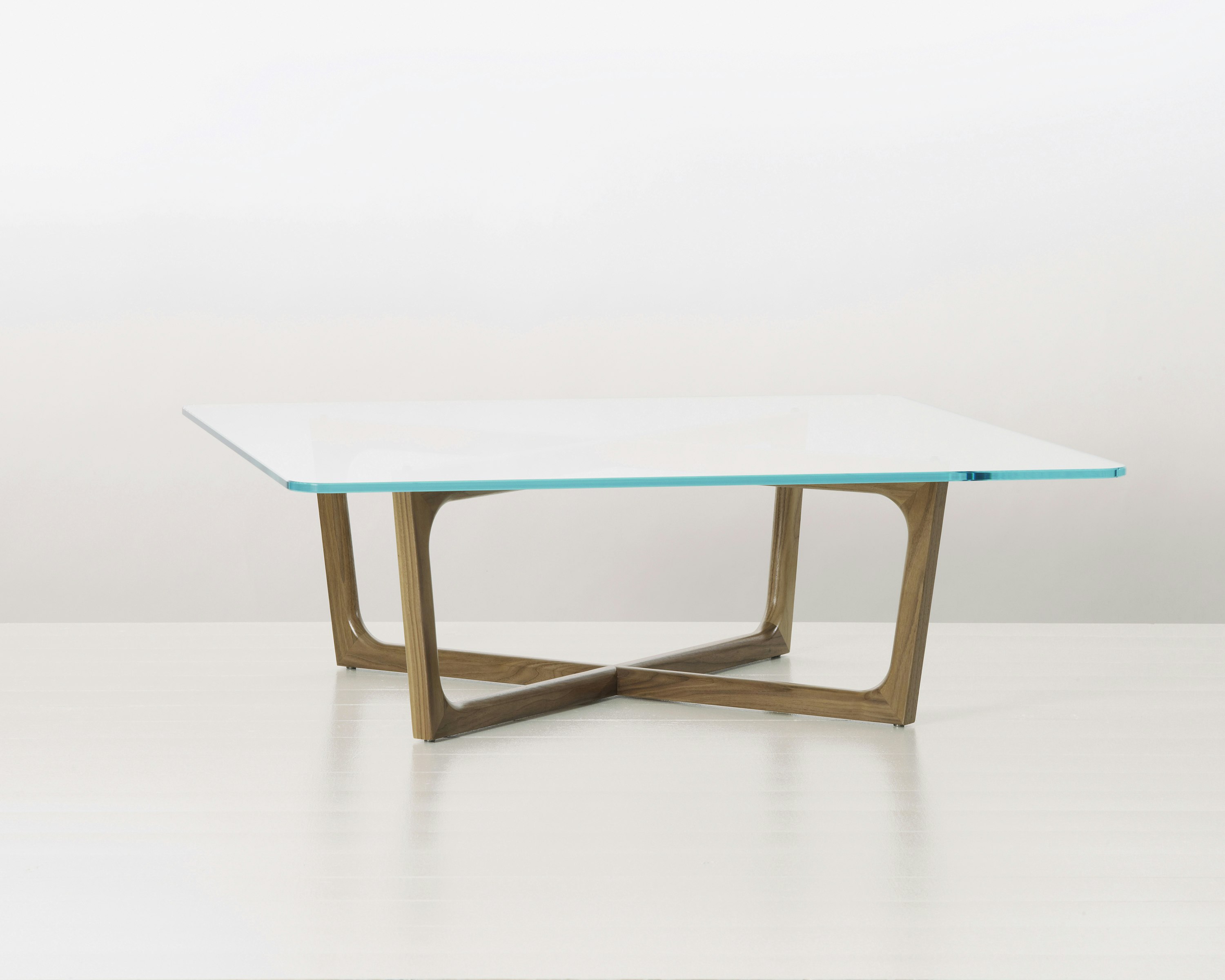 A square Loophole coffee table with a glass top and walnut base.