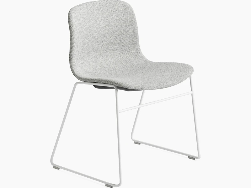 About A Chair grey upholstered seat shell on white wireframe sled base, front angled view.