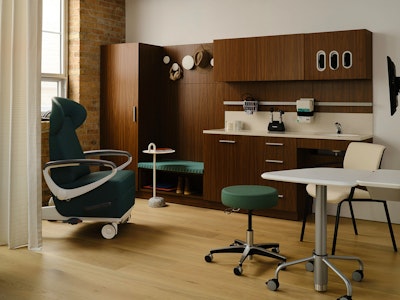 A green Herman Miller Nemschoff Ava Recliner, wooden Herman Miller Mora System, and other healthcare furniture from the MillerKnoll collective displayed in a showroom