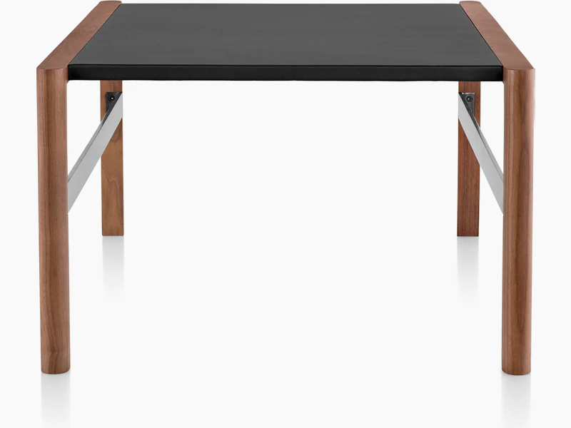 A Brabo side table with a black leather-wrapped top, walnut frame, and metal frame supports, viewed from the side.