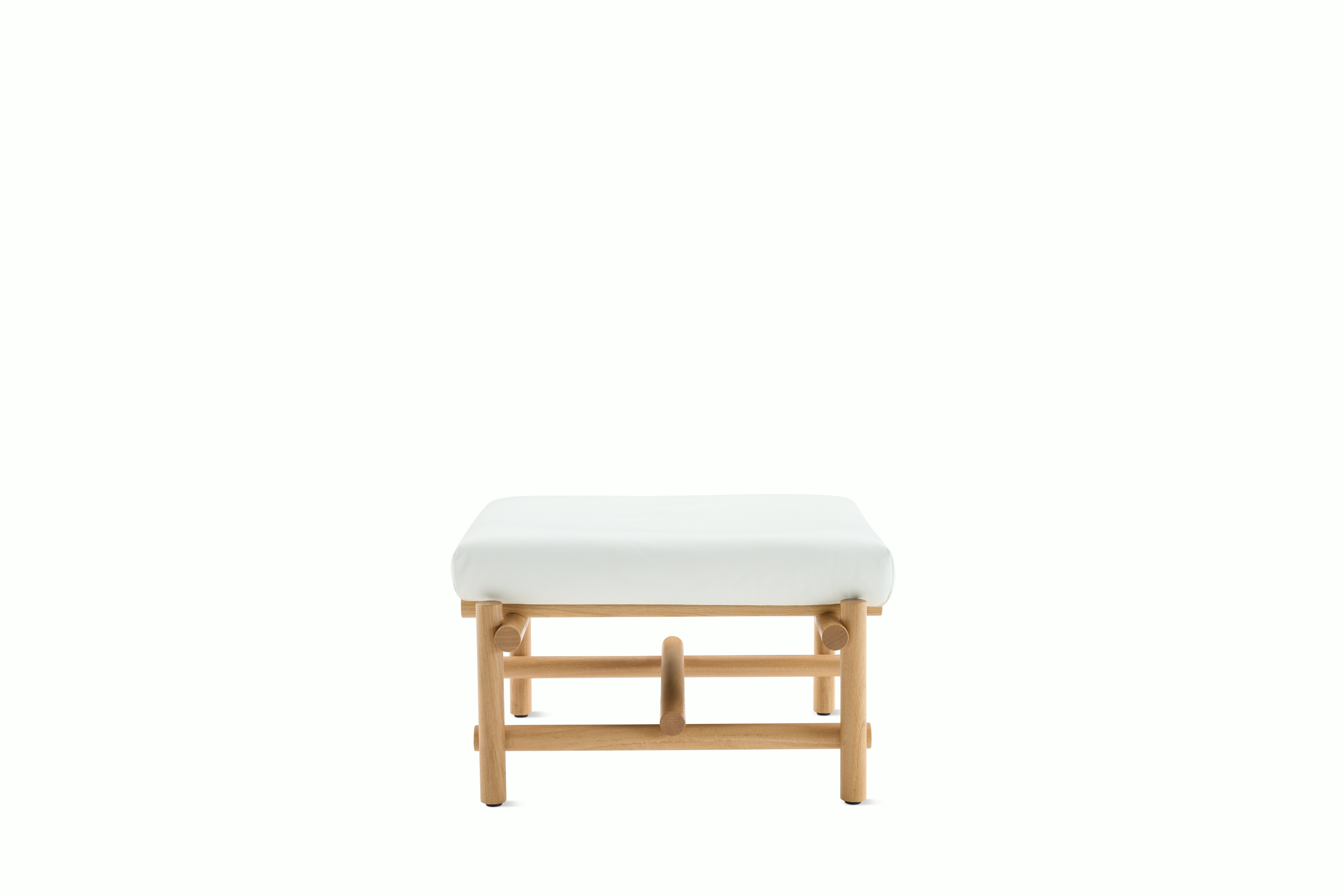 A Muecke Ottoman in White White Oak viewed from the front.